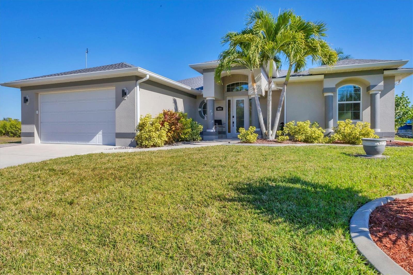 Do you dream of hopping on your boat and fully embracing the Florida lifestyle? This newer custom pool home not only delivers that dream—it elevates it. Perfectly oriented to the east, it welcomes you with beautiful Florida mornings and warm natural light throughout the day. If you're seeking luxury, convenience, and a slice of paradise, look no further. As you step through the stunning entry, what will captivate you first? Perhaps it's the beautifully mixed flooring—porcelain tile laid on the diagonal flowing through the main living areas and engineered hardwood in all bedrooms. Maybe it’s the impressive light fixtures that highlight the soaring ceilings in the foyer and great room. Or will it be the 12 feet of glass sliders that fully pocket away, inviting the outdoors in and creating a true indoor–outdoor living experience? This home is designed to impress at every turn. The heart of this residence is the exquisite kitchen. Granite countertops offer elegance and generous workspace, while a large island and abundant maple wood cabinetry combine style and function. Culinary enthusiasts will appreciate the stainless-steel appliance suite, custom hood vent, built-in wall oven, wine fridge, glass tile backsplash, and under-sink water filtration system—thoughtfully curated to elevate both form and performance. Step onto the expansive 25' x 9' lanai, where you’ll likely spend much of your time. Beyond the covered space, an extended pavered patio provides additional room for outdoor entertaining—perfect for grilling, lounging, or hosting gatherings. The heated saltwater pool glistens as the centerpiece of this outdoor oasis. From your lanai and patio, enjoy serene views of your private natural habitat and boating hub, offering unmatched peace and privacy on the Cape Haze Peninsula. For boating enthusiasts, the private dock with a 12,000 lb lift makes setting out on the water effortless. Whether you're heading to the Gulf or exploring nearby waterways, your adventures begin just steps from your back door. Back inside, the master suite serves as your personal sanctuary. It features one expansive walk-in closet, a dedicated entry to the lanai, and a linen closet—balancing comfort with convenience. The spa-like en-suite bath offers dual vanities and a luxurious Roman shower designed for relaxation. The guest wing is thoughtfully designed for privacy, with two bedrooms and a shared bathroom that provides direct pool access while maintaining separation from the lanai. Additional highlights include high-speed internet, concrete-curbed landscaping, a finished laundry room, irrigation system, and full home hurricane protection for peace of mind. Located just minutes from Boca Grande and Manasota Key beaches, this home provides quick access to some of Florida’s most stunning coastline and endless outdoor activities. If you’ve read this far, congratulations—you’ve found your next home. A sanctuary crafted for living, entertaining, and embracing everything Florida has to offer. Are you ready to make it yours? The lot next door is available for purchase as well MLS#c7514431.