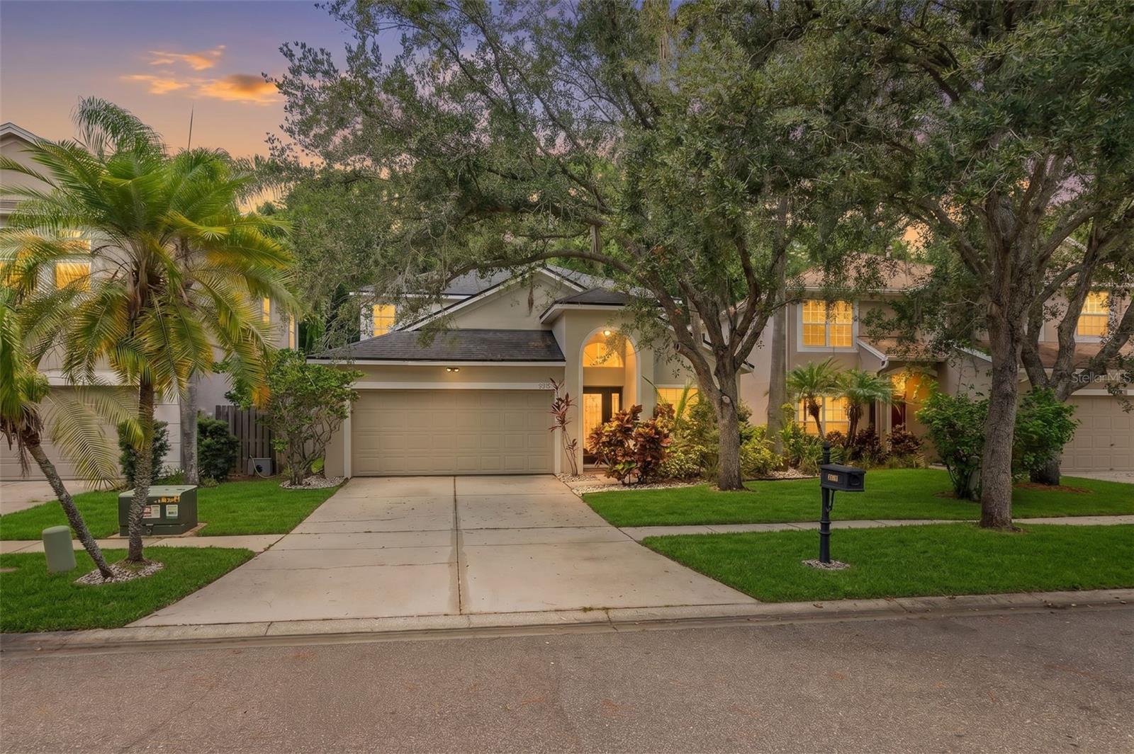 Located at 9915 Hartwell Bridge Circle in the heart of Westchase, this professionally redesigned 4-bedroom, 2.5-bath home showcases a spectacular designer kitchen, dramatic custom media wall, and premium conservation homesite with no rear neighbors. Completely transformed in 2025 and situated on a quiet cul-de-sac, this move-in-ready home offers 2,362 heated square feet and a spacious 2-car garage. Just steps from West Park Village, Westchase Elementary, neighborhood parks, playgrounds, restaurants, cafés, boutique shopping, and community events, you'll enjoy one of Tampa's most walkable neighborhoods. Inside, soaring two-story ceilings, luxury vinyl plank flooring, recessed LED lighting, custom wall detailing, and walls of windows create a bright, inviting atmosphere. The welcoming foyer is flanked by formal living and dining rooms, offering elegant spaces for entertaining. Beyond, the dramatic two-story family room is highlighted by a custom floor-to-ceiling media wall featuring illuminated wood slat accents, built-in bookshelves, display niches, integrated lighting, and a recessed media center. The completely redesigned kitchen was thoughtfully created for everyday living and entertaining, featuring custom soft-close shaker cabinetry, quartz countertops, an oversized waterfall-edge quartz island with fluted wood detailing and seating for four, designer tile backsplash, under-cabinet lighting, stainless steel appliances, natural gas range, built-in pantry, and abundant storage. Open to the family room, it also offers peaceful views of the backyard and conservation preserve. Privately located on the first floor, the spacious primary suite features two walk-in closets and a beautifully renovated ensuite with dual vanities, freestanding soaking tub, and oversized walk-in shower. A renovated powder bath and full-size laundry room complete the main level. Upstairs you'll find three generously sized bedrooms, each with its own walk-in closet, a versatile loft, and a beautifully updated full bath with dual sinks and a tub/shower combination. Every bathroom was renovated during the 2025 remodel, and every bedroom includes a walk-in closet. Step outside to the covered, screened lanai overlooking the fully fenced backyard and tranquil conservation preserve. With no rear neighbors, this private outdoor space is perfect for relaxing, entertaining, or enjoying peaceful nature views. Additional improvements include a new HVAC in 2023 and a complete renovation in  2025 featuring the redesigned kitchen, renovated bathrooms, and new stainless steel appliances. The home also includes a natural gas water heater and natural gas range. Westchase residents enjoy exceptional amenities for only $477 annually, including two community pools, tennis courts, pickleball courts, parks, playgrounds, miles of sidewalks, and year-round community events. Conveniently located near the Veterans Expressway, Tampa International Airport, downtown Tampa, golf, shopping, dining, and top-rated schools. Professionally redesigned with timeless finishes, a premium conservation homesite, low HOA fees, and one of Westchase's most desirable walkable locations, this is a rare opportunity to own one of the community's most thoughtfully updated homes. Schedule your private showing today.