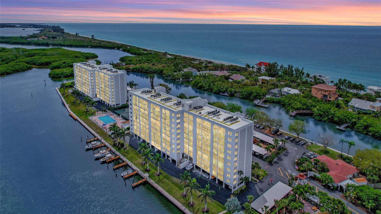 Private & gated Community on the Southern tip of Siesta Key with 180-degree water views!  Sunrise and Sunsets both frame the 5.3 acres of manicured natural beauty! 
This renovated 2 bed/2 bath condo offers the perfect blend of coastal comfort and modern convenience! This 5th floor unit boasts a well-designed layout, featuring a clear separation between bedrooms and family gathering spaces.  This allows for privacy and relaxation while still promoting connection.

Step inside and be greeted by an abundance of natural light, accentuated by the seamless flow onto the expansive 29 ft. long glass/screen enclosed Lanai Terrace.  The renovated kitchen and bathrooms feature solid wood cabinetry, granite countertops and stainless-steel appliances, creating a sleek and modern feel. 

No more weekend chores!  Ceramic and porcelain tiles throughout the living areas provide easy-to-maintain elegance, while the newer upgraded carpet in the bedrooms offers plush comfort.  This condo is move-in ready and can be purchased furnished (with certain items excluded) for your ultimate convenience.  Relax on the lanai and enjoy the balmy breezes thanks to the screened glass sliders, pocket-screened entrance storm door and custom window treatments. 

Situated on the southern tip of Siesta Key, this iconic and historic community offers the best of both worlds.  Witness breathtaking sunrises over the Sarasota Bay and Neville Bird Sanctuary and unforgettable sunsets over the Gulf of Mexico. Immerse yourself in the luxurious amenities including a heated lap pool & spa, tennis and pickleball courts, fitness room, sauna rooms, a community gathering center and much more!  Kayak and canoe storage is available for a nominal annual fee, and boat slips can be rented for a monthly fee. Enjoy the private island with a fishing pier, gazebo, butterfly garden, and grills- perfect for outdoor picnics or entertaining.  

This gated community provides security and peace of mind, with on-site property management and maintenance for your convenience. Dual elevators ensure easy access, and a dedicated walking path along the water allows you to enjoy the beautiful Florida surroundings. 

Location – location – location!  The Pointe is ideally situated close to the free public trolley (.3 mile)  taking you directly to the world-famous Siesta Beach and vibrant Siesta Village. It’s also close to Turtle Beach (.4 mile) and several notable restaurants (.5 mile).

Don’t delay – your Paradise in Florida is waiting for you!