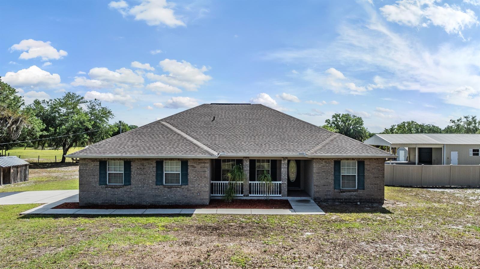 5 FULL ACRES, THIS IS COUNTRY LIVING AT ITS BEST WITH NO HOA! Bring your horses, boats, recreational vehicles, business or simply spread out with this custom-built home with plenty of room to add a pool and also includes several outbuildings close to the southeast corner of Hillsborough County. The 3-bedroom, 2-bath design has 9'4 ceiling heights throughout with a tray ceiling in the primary suite. The plan also centers everything around a spacious great room that opens through sliders to a screened porch and the sliders recess into the wall. There's a formal dining room in front as well as a windowed breakfast nook beside the open kitchen, which really stands out with raised-panel wood cabinets and split-level countertops. The home also has a central vac system. The roof and A/C were replaced in 2022, a brand new 50 gal HWH and a new tank and well pump. Home has maintained an annual pest control service. Other extras include designer lighting, a leaded-glass entry door and a spindle-rail front porch. Of course, the value of the property extends far beyond the flexible floor plan. You also get a metal workshop that is 30 x 40 with a 24 x 30 attached carport and a 10 x 12 rollup door with water and electric. There is also a smaller metal shed beside it that is 12 x 20 which comes with a Air Compressor-80gallon with 100' hose reel in the workshop. There is also a 40 x 40 pole barn that is perfect for parking your boat, toys or RV.  There is a 10 x 12 horse stall next to a chicken coop that measures 8 x 8. The chicken coop has great bones it just needs some TLC.  Acreage around the home is level, cleared, and mostly fenced.  You are within 10 minutes of a major shopping site and commuter routes to Tampa or Sarasota, yet you're miles away in terms of peace and privacy!