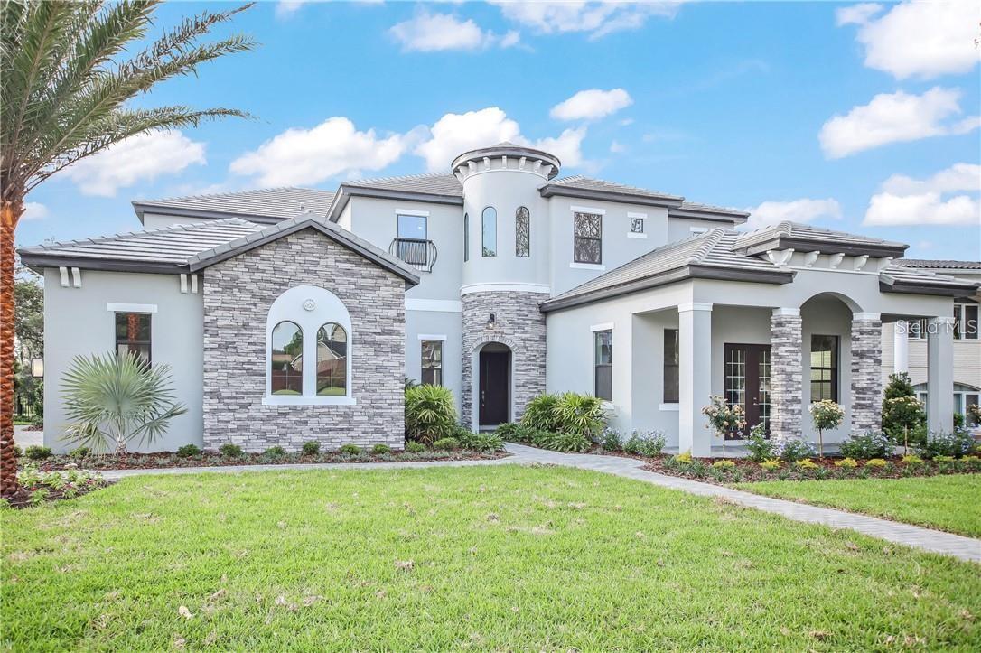 Magnificent home set directly on 3rd Tee overlooking a lake in Arnold Palmer’s Bay Hill Golf Community. This superb home boasts over 5800 sq ft with roaring 12 ft ceilings throughout the first floor and 1O ft ceilings on second floor. This home offers 6 Bedrooms, 5 bathrooms and 2 half baths. Upon entering you will find the dining room, butler’s pantry and the massive kitchen with large island. The open concept kitchen, eating area and family room over look the pool, golf course and lake. The Master suite is located on the first floor, has 2 oversized walk-in closets and a beautifully designed en-suite. The pool bedroom and bathroom allows your guest easy access to their suite. Enjoy a private study with its own private entrance. There are 2 laundry rooms positioned on each floor. The upstairs consists of 4 bedrooms - 2 of the bedrooms have walk-in closets and en-suites, a movie theater with stadium seating, large bonus room and a half bath. Enjoy breathtaking views of Championship Golf Course. Welcome Home to 3rd Tee.