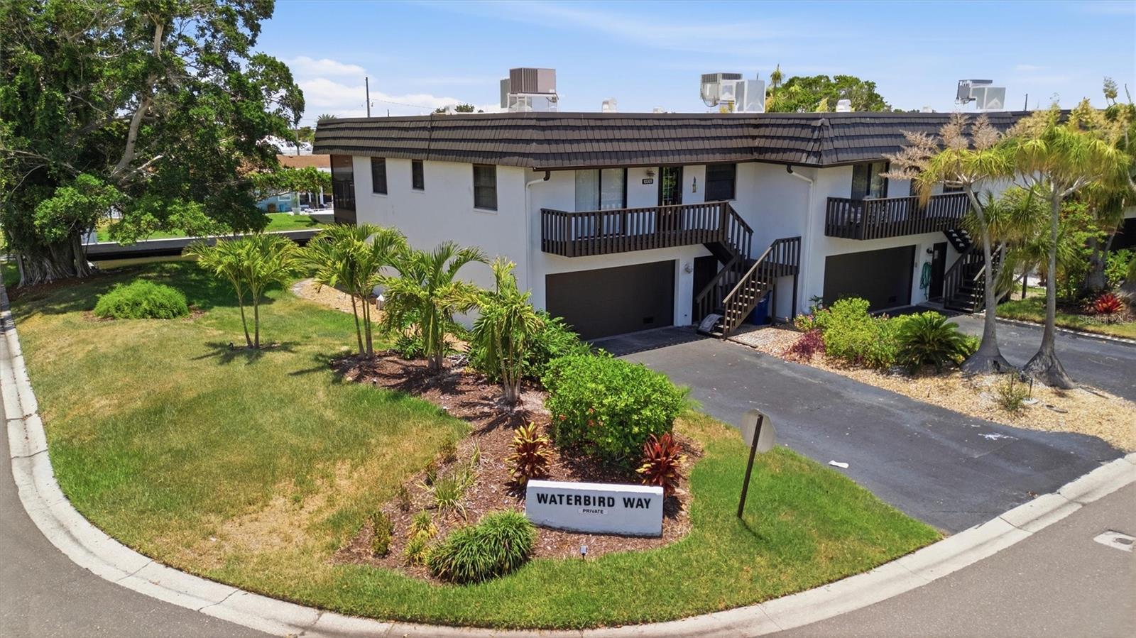 Experience the best of Florida waterfront living in this turnkey furnished 2-bedroom, 2-bath townhouse, ideally located just 2.5 miles from the pristine Gulf beaches. Tastefully decorated with coastal-inspired furnishings, this move-in-ready home overlooks a peaceful saltwater canal and includes your own private dock, offering effortless boating access to the Intracoastal Waterway and the Gulf of Mexico. The light-filled main living area features crown molding, an open floor plan, and sliding glass doors that lead to a screened lanai overlooking the canal—the perfect spot to enjoy your morning coffee or unwind at the end of the day. The spacious 14' x 27' lower-level bonus room opens to a second screened lanai, creating an ideal guest retreat, home office, media room, fitness space, or recreation area. A 2-car garage provides ample storage for vehicles, kayaks, paddleboards, bicycles, and all your beach and boating gear. Whether you're spending the day on the water, relaxing on the beach, or simply taking in the tranquil canal views from one of two screened lanais, this home is designed to embrace the Florida lifestyle. Residents also enjoy a variety of community amenities, including a heated swimming pool, tennis/pickleball court, and basketball court, providing plenty of opportunities to stay active and socialize with neighbors.Whether you're looking for a full-time residence, a seasonal escape, or a waterfront retreat, this home offers the rare combination of private boating access, resort-style amenities, and a prime location just minutes from the Gulf's sugar-sand beaches.