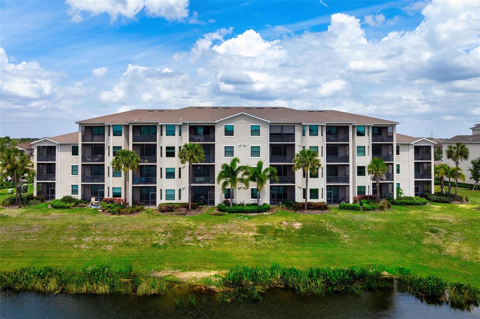 Imagine starting your morning overlooking the water and lush greens as Lakewood National quietly comes to life, knowing your day can be as active or as relaxed as you choose; tee time on two Arnold Palmer championship courses, a match on the pickleball courts, or a slow afternoon by the resort-style pool. This newer, turnkey/furnished second-floor 2-bedroom, 2-bath condo offers an effortless lifestyle, with a light, open floor plan featuring quartz countertops, stainless steel appliances, light cabinetry, and an island that naturally becomes the gathering place for entertaining. The split-bedroom layout provides privacy for guests, while the spacious primary suite sits peacefully at the back of the home, capturing serene lake, golf, and preserve views, with two walk-in closets that flow into a well-appointed bath and generous walk-in shower. The screened lanai quickly becomes your favorite retreat; quiet, private, and perfect for unwinding at the end of the day. With a storage unit just outside your door for golf clubs or bikes, a designated parking space steps from the elevator, and a satellite pool nearby for easy social connection, convenience is built into every detail. And when you’re ready for more, the main clubhouse delivers a true resort experience with a zero-entry pool and spa, tiki bar dining, fitness center, full-service health & beauty spa, tennis, pickleball, and world-class golf, rated #1 in GolfPass with the remainder of the year paid in full. Pet- and renter-friendly with flexible monthly leasing options, this is not only a lifestyle upgrade but a smart investment in the #1 master-planned community in the country, surrounded by dining, shopping, and everything Lakewood Ranch has to offer.