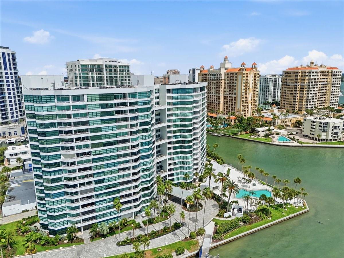 Virtually Staged. Completely renovated 2-bedroom, 2-bath residence on the 7th floor of Tower I at Condo on the Bay, offering full bay views over Sarasota Bay and a romantic view of the Ringling Bridge. The reimagined floor plan relocated bedroom doorways for enhanced privacy between the primary suite and guest bedroom, and both bedrooms now feature oversized walk-in closets. The open-concept kitchen has been fully reimagined with all-new appliances, granite counters, and a breakfast bar that’s ideal for entertaining while taking in the water views. Additional highlights include split-bedroom design, solid surface counters, solid wood cabinetry, and a spacious outdoor balcony overlooking the bay. Residents enjoy resort-style amenities within this guard-gated community: 24-hour security, clubhouse, multiple fitness centers, two heated pools, tennis and pickleball courts, a marina with fishing piers, boat slips that allow boat lifts and kayak storage, and kayak lifts. Assigned garage parking and guest parking are included. Located adjacent to Sarasota’s 53-acre park called “The Bay” with an outdoor cinema, sunset beach, tropical boardwalk and multiple entertainment venues. Condo On The Bay is also located within a short walking distance to over 20 restaurants, cafes, and shopping. Move-in ready for the buyer seeking a true waterfront lifestyle in the heart of Sarasota.