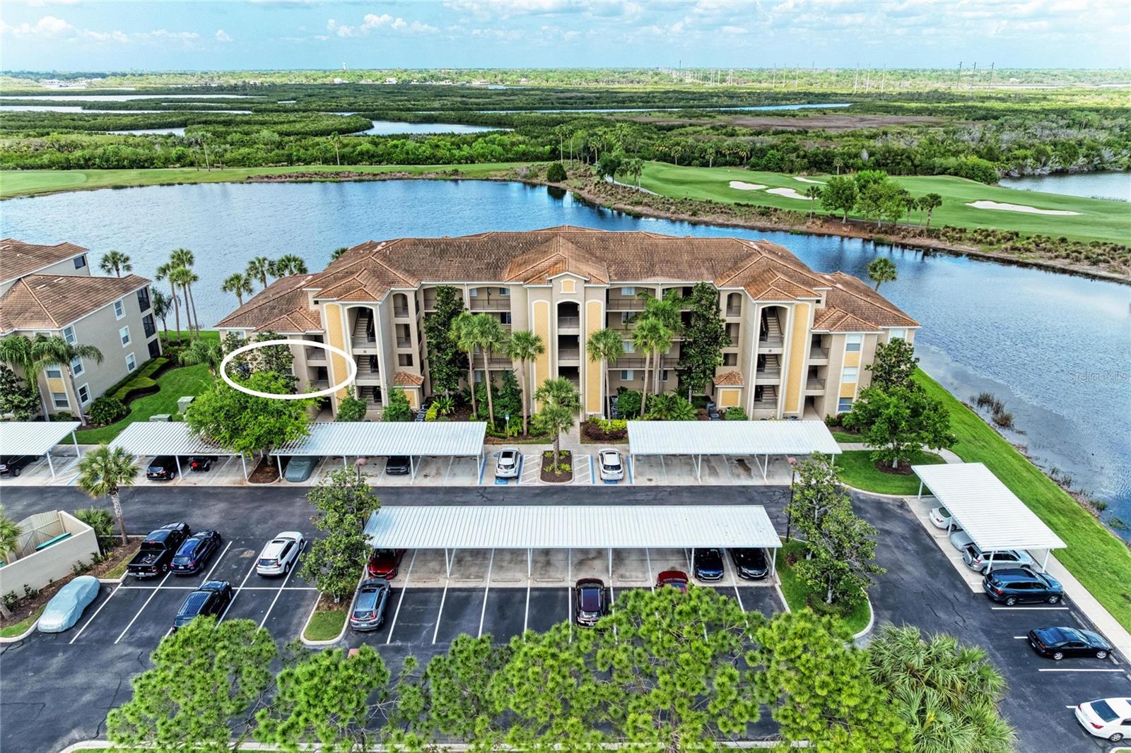 JUST REDUCED!  BRING ALL OFFERS!! Move right into this beautifully maintained second-floor END UNIT  in the gated, resort-style community of River Strand Golf & Country Club! This spacious GOLF DEEDED  and FURNISHED home features the Colonnade floor plan which  offers extra privacy and an abundance of natural light, along with the breathtaking golf course and water views the community is known for.

The open-concept living and dining area is perfect for entertaining, seamlessly connected to an eat-in kitchen featuring a breakfast bar and plenty of space for casual dining. The generously sized primary suite includes dual walk-in closets and a well-appointed en-suite bath. A comfortable guest bedroom with an adjacent full bath ensures both convenience and privacy for visitors.

Step through sliding glass doors to your private screened lanai, where you can relax and take in sweeping panoramic views—an ideal spot to enjoy Florida’s beautiful sunsets!

This FRESHLY PAINTED unit feels light, bright, and move-in ready. As an end unit, it also offers a versatile bonus flex space, perfect for a home office, den, or additional guest area. Additional features include a full laundry room, extra storage closet just across the hall, and a designated covered carport.

Residents of River Strand enjoy access to a recently renovated clubhouse featuring a RESTAURANT, GRILLE ROOM with expanded outdoor dining, newly redesigned terrace bar overlooking the resort-style pool and spa—offering the ultimate in an elevated lifestyle. The community’s crown jewel is its 27 holes of pristine championship golf. Residents also enjoy an impressive array of amenities, including tennis and pickleball courts, two main resort-style pools and spas, six additional satellite pools, and two fully equipped fitness centers. A vibrant calendar of social events and fitness activities offers something for everyone.

Ideally located just minutes from I-75, you’ll have easy access to the new Marketplace featuring Costco and Target, while the stunning Gulf Coast beaches are only a short drive away—making this the perfect place to enjoy the best of Florida living....Once you experience this home and River Strand at it's best you may never want to leave!