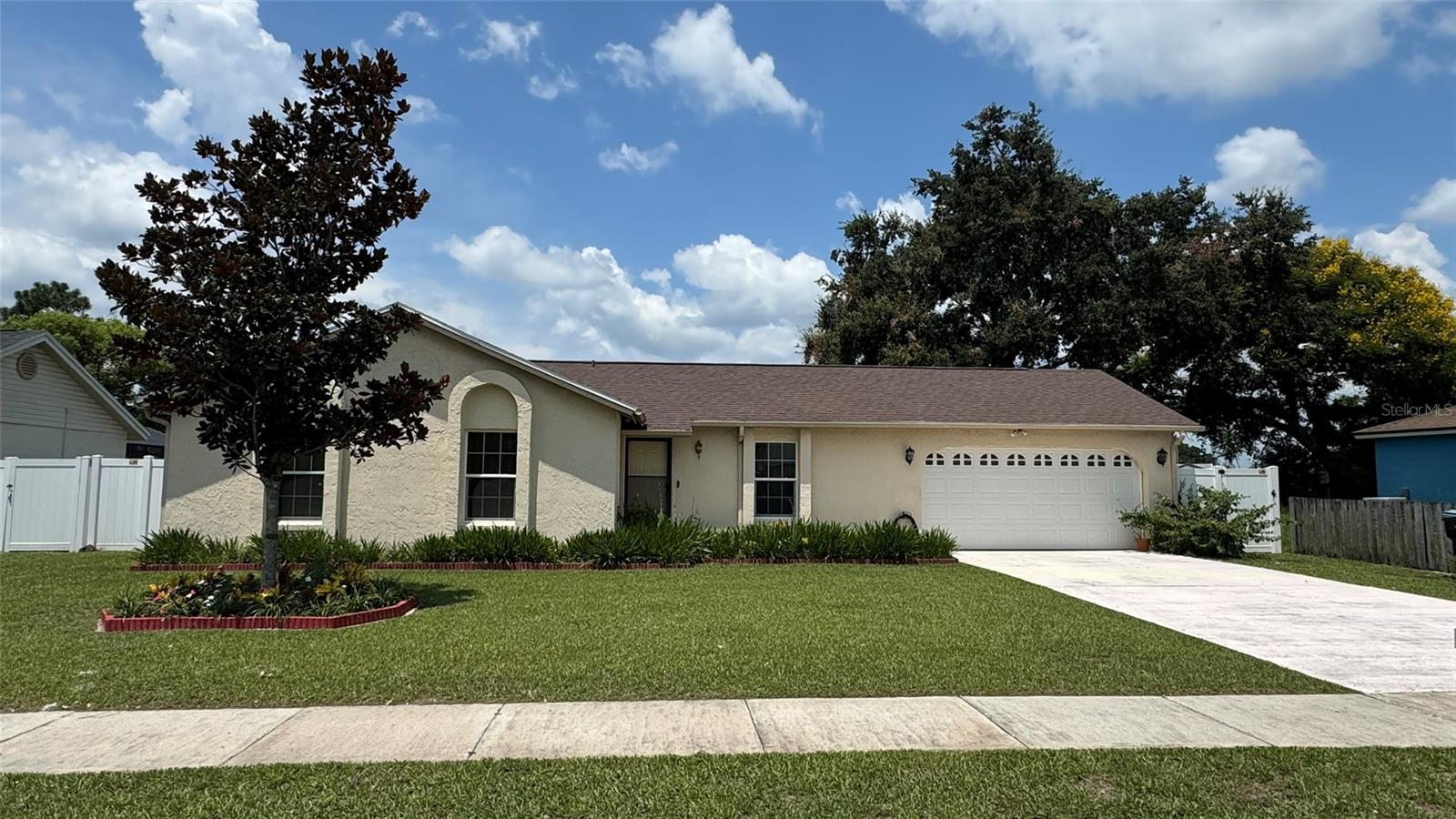 Welcome to this beautifully maintained 4-bedroom, 2-bath home in the heart of East Orlando!  With thoughtfully designed living spaces, this single-story residence features an open and inviting floor plan with soaring ceilings that create a bright, spacious feel throughout the main living areas.  The well-appointed kitchen comes complete with a refrigerator, dishwasher, built-in oven, range hood, washer, and dryer, making this home truly move-in ready.  Durable laminate flooring flows through much of the home, while ceiling fans and central air conditioning provide year-round comfort.  Step outside to enjoy the fully fenced backyard—perfect for entertaining, pets, or creating your own outdoor oasis.  A covered rear porch leads to an exterior air-conditioned bonus room with private access.  A storage shed, mature landscaping, and an attached two-car garage add both functionality and convenience.  Ideally located just minutes from shopping, dining, parks, schools, Orlando International Airport, and major highways including SR 408, SR 417, and SR 528, this home offers an easy commute to Downtown Orlando, Lake Nona, and area attractions.  Don't miss this fantastic opportunity to own this hidden treasure in beautiful east Orlando. Schedule your private showing today!