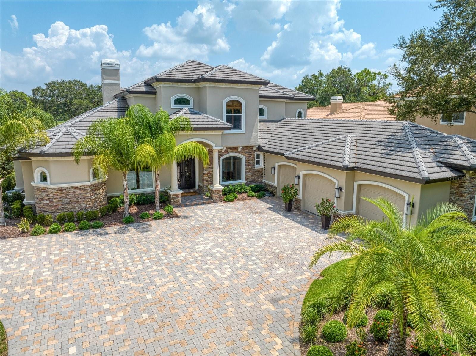 This magnificent home, overlooking the 15th Island Course of the World Renowned Innisbrook Golf, Spa and Tennis resort, Home to the Valspar Championship, is an exquisitely updated showcase. Upon entering the double front doors, one’s eyes quickly are trained on the fabulous in ground pool and golf course visible thru the living room’s hurricane rated accordion sliding doors, opening to the outdoor sitting area featuring a fireplace and TV. The Living Room with its fireplace provides a comfortable gathering area to catch up with friends. The living room and foyer both feature electronic chandelier caddies easing maintenance. The Dining Room features a beautiful chandelier and hidden uplighting providing the perfect atmosphere for elegant dining pleasure. Double doors off the living room lead to the first-floor office which incorporates dark wood built-ins. Modern elegance is how to define the Kitchen which features white and gray porcelain tile flooring, white quartz countertops, new expresso shaded, self-closing cabinets accent the stainless-steel appliances which include a dishwasher, SubZero refrigerator, 6 burner gas stove and double oven; wine refrigerator and convection microwave. Walk-in Pantry and separate Coffee bar add elegance for entertaining guests. Store your favorite bottles of vino behind glass encased temperature-controlled wine cellar conveniently located just off the Kitchen. Double doors from the Kitchen lead to your Entertainment wing featuring wood floors over a cork base for sound deadening; wall mounted TV with high end Atmos speakers w/AV equipment, back lite, cocktail bar. The Bar features an under-counter wine refrigerator and dishwasher. A full bath featuring a steam shower provides access directly from the entertainment room as well as access from the pool area.  The Owner Suite includes a double-sided fireplace, a sitting area with breathtaking views of the pool and golf course. Dual walk-in closets provide ample space. From the bedroom, feast your eyes upon your master bath which rivals those seen in magazines and showrooms. A soaking tub is the center piece of the room with a walk-in glass encased semi-circled rain shower at one end and dual vanities and cabinets on either side of the room. An additional Guest Bedroom with full bath provides a quiet getaway to accommodate guests or additional family members. A half bathroom off the kitchen and a large laundry room with ample cabinets and conveying washer and dryer completes the first level. Upstairs loft area includes a kitchenette, built-in desk and covered terrace overlooking the golf course. Two bedrooms each with their own full bathroom complete this level. Entertain guests with ease in the pool area which provides ample dining and sitting areas along with a new outdoor kitchen and bar. Heated and cooled, pebble tech, saltwater pool provides virtually year-round enjoyment. Other features include new water heater, (3) newer A/C units; Tesla charging station in A/C garage and natural gas generator. Resort membership offers 4 golf courses including the famed Copperhead course.  Other resort amenities include: 9 tennis courts, pickleball, Fitness Center, Spa, heated pools and several on-site restaurants.  Resort is minutes away from area attractions including Clearwater Beach, Dunedin, Pinellas Trail, Honeymoon Island, Caladesi Island Ferry, Tampa airport, Raymond James stadium and Amalie Arena.