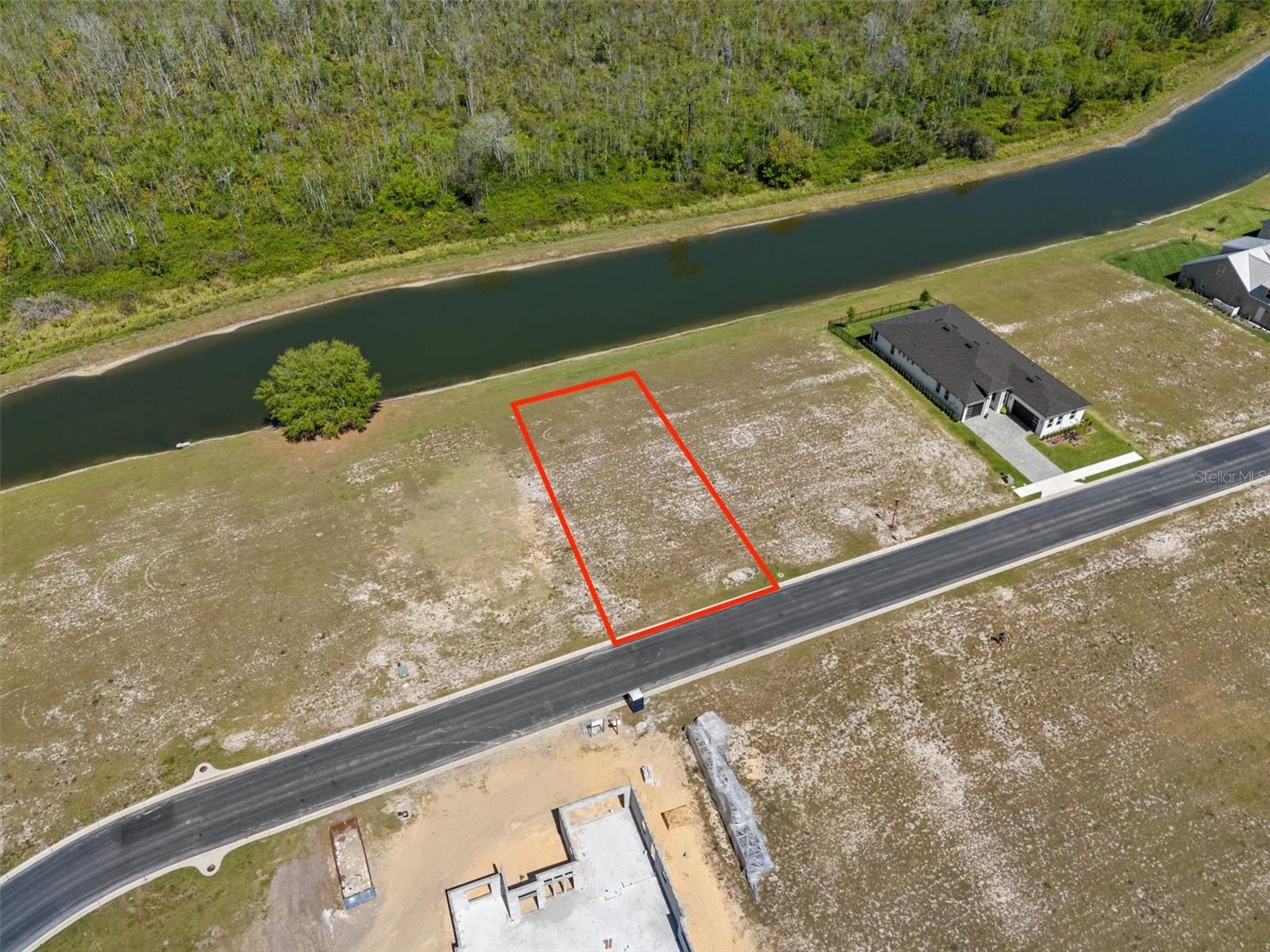 Discover the perfect canvas for your custom dream home, nestled in the highly sought-after Water Ridge community in Auburndale, Florida. This premium homesite offers a tranquil setting with a scenic, expansive ribbon pond at the back, providing stunning water views and the added privacy of a nature preserve area beyond the water. Located in a gated, resort-style community, Water Ridge boasts exclusive amenities, including multiple pools, a clubhouse, fitness center, tennis courts, and much more! Residents have access to Lake Van, Lake Alfred, and Lake Medora, which is ideal for boating, fishing, and outdoor recreation. Conveniently situated between Orlando and Tampa, this location offers easy access to major highways, shopping, dining, and entertainment while maintaining a peaceful, secluded feel. Don’t miss this rare opportunity to build your custom home in one of Central Florida’s premier lakefront communities. Schedule your visit today!