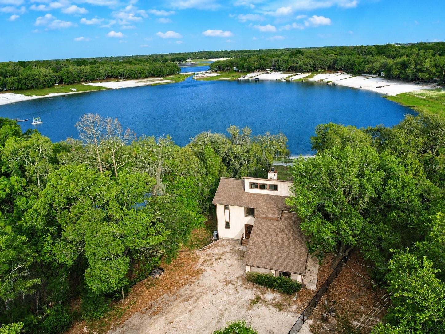 Check out this stunning 4 bedroom, 4 bathroom lakefront home on Lake Brooklyn! Enjoy breathtaking lake views while sipping your morning coffee from the massive covered porch. Inside, you’ll love the soaring vaulted ceilings with exposed beams that create the perfect cozy cabin feel, along with a beautiful wood-burning fireplace. Vinyl plank flooring runs throughout the home, making maintenance easy and efficient. Three of the four bedrooms feature their own private en-suite bathrooms, offering exceptional comfort and privacy. Upstairs, both bedrooms include private balconies overlooking the property and lake. Downstairs features a spacious living area, private bedroom, and full bathroom, making it ideal for an in-law suite, guest quarters, or even a potential income-producing apartment. Complete with a private dock, this home is perfect for enjoying lake life to the fullest. Don’t miss your opportunity to own this incredible waterfront retreat!