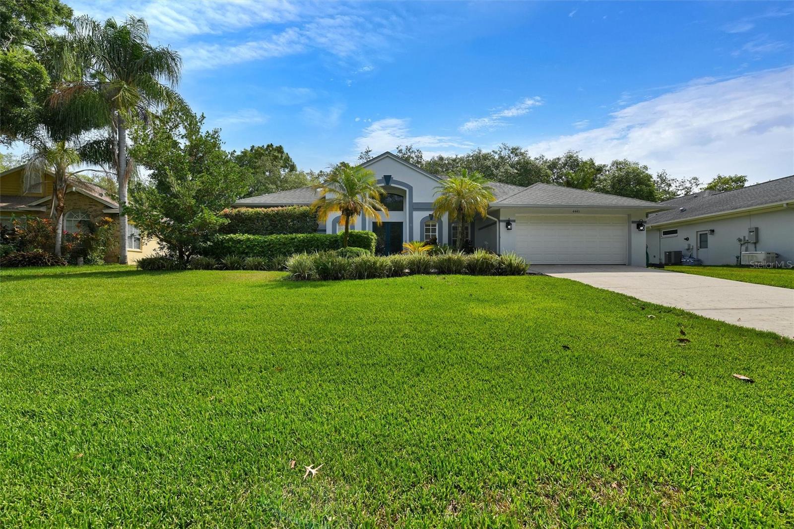 Welcome home to this lovely 4 bedroom, 3 full bath, 2 car garage pool home on a large park like setting in Glenbrook West. The large almost .4 acre lot sits up high off the road with grand trees and mature landscaping. When you enter through the Double Front Leaded Glass Doors you will feel right at home. The house has an Open Floor Plan with High Ceilings Throughout and a 3 way Split Bedroom arrangement. The Living Room, Dining Room and Primary Bedroom all have Hard Wood Flooring. The Living Room and Primary bedroom both have sliding door access to the covered seating area by the pool. The Primary Bedroom also has a huge Ensuite Bathroom with Dual Sinks and Stone Counter Tops. There is a large window providing plenty of light, a garden tub, walk in shower and walk in closet with custom built in features. On the other side of the house you will find the open Family Room, Family Dining Area and Kitchen with Raised Panel White Cabinetry, Stone Counter Tops and Stainless Steel Appliances. Large Island with Breakfast Bar. The pantry with a sliding barn door provides loads of storage space. The laundry room is also conveniently located between the kitchen and the garage. As you enter into the family room there are 2 large bedrooms and one full bath with a tub /shower combination off to your right. A Wood Burning Fireplace adds a sense of comfort and charm. There are two sets of sliding doors in this area and the largest of the two are pocket sliders which can be pushed all the way open to allow complete open living concept within the screen enclosed pool area. The kitchen is close by to provide breakfast, lunch or dinner on the Lanai. At the far end of the Family Room you will find the 4th bedroom and a large Pool Bath with walk in shower. This area of the home has beautiful tile flooring for ease of maintenance around the pool. The Screen Enclosed area has plenty of sun bathing space and plenty of shaded area under roof. The built in cabinetry and wet bar with buffet counter are great when entertaining or just relaxing. The back yard is filled with beautiful shade trees and even has a tree swing! Great Neighborhood and Schools! Close to everything Palm Harbor has to offer, Great Shopping, Dining, Golfing, Beaching and Entertainment. Not Far from Tampa, Clearwater, Dunedin and destinations North! This could be the one! Call for private showing.