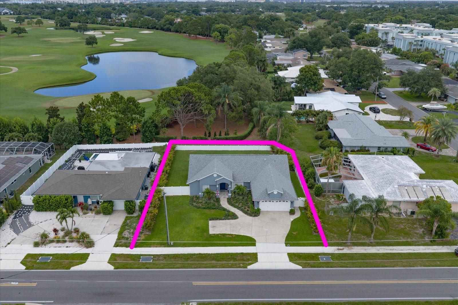 Welcome to this stunning, move-in-ready Belleair home where exceptional curb appeal, tropical landscaping, and timeless style create an inviting first impression. Step inside to a bright, open interior filled with natural light and enhanced by beautiful flooring throughout. The heart of the home is a spectacular kitchen designed for both everyday living and effortless entertaining, featuring an oversized island with pendant lighting, gorgeous countertops, and stainless-steel appliances. The open layout flows seamlessly into the formal dining room, creating the perfect space for gathering with family and friends. The desirable split-bedroom floor plan offers privacy and comfort, highlighted by a spacious primary suite that feels like a private retreat. The luxurious ensuite features dual sinks, a custom-tiled walk-in shower, and a beautifully designed custom walk-in closet. The additional bedrooms are equally inviting, offering abundant natural light, generous closet space, and access to a beautifully updated hall bath with a tub/shower combination. Step outdoors to a private backyard oasis showcasing breathtaking views of the Pelican Golf Course and plenty of room to create your own poolside retreat. Ideally located in the highly sought-after Town of Belleair, this exceptional home is just minutes from world-class golf, charming boutique shops, local restaurants, and the area's renowned Gulf beaches, offering the perfect blend of elegance, comfort, and the Florida lifestyle.