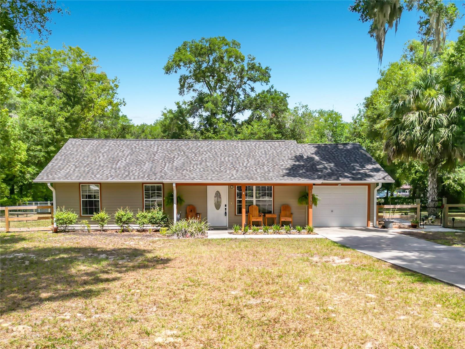 Country Living at Its Finest on 1.34 Acres!

Welcome home to your own private paradise! Situated on 1.34 beautifully fenced acres, this fully updated 3-bedroom, 2-bath pool home is move-in ready and offers the perfect blend of comfort, functionality, and outdoor living.

Step inside to discover gorgeous, neutral flooring that complements any décor and a thoughtfully designed floor plan with no wasted space. The beautifully renovated kitchen features rich wood cabinetry with stylish stainless hardware, a stunning copper backsplash, and stainless steel appliances, including the refrigerator, range, microwave, and dishwasher. A spacious dining area sits just off the kitchen, while the open-concept layout flows seamlessly into the family room, making entertaining family and friends effortless.

The primary suite offers a private, updated en-suite bath with a tub/shower combination. Two additional bedrooms share a beautifully updated full bath. An indoor laundry room adds everyday convenience.

Outdoor living is where this property truly shines! Relax in the large screened lanai, entertain under the covered outdoor kitchen, or cool off in the sparkling 2022 pool. The fully fenced yard is dotted with mature shade trees, creating a peaceful setting to enjoy Florida's beautiful weather.

Need space for hobbies, toys, or a business? The impressive 60' x 30' workshop features three roll-up bay doors, a solid concrete slab foundation, its own 200-amp electrical service, and an additional 30' x 15' covered carport. The workshop is easily accessible from the front gate or the private rear easement, offering exceptional flexibility for RVs, boats, equipment, or projects.
For additional peace of mind additional updates are new HVAC 2024, new roof 2025, new hot water heater 2025

Conveniently located just 14 miles from The Villages and 18 miles from Ocala, you'll enjoy easy access to shopping, dining, medical facilities, and entertainment while still embracing the tranquility of country living. Outdoor enthusiasts will appreciate being just minutes from Lake Weir with its clear water and white sandy beaches, Gator Joe's Beach Bar & Grill, the Ocklawaha Dam, and the beloved The Duck Dam Diner.

This exceptional property truly has it all—modern updates, incredible workshop space, resort-style outdoor living, and the peaceful country lifestyle you've been searching for. Schedule your private showing today!