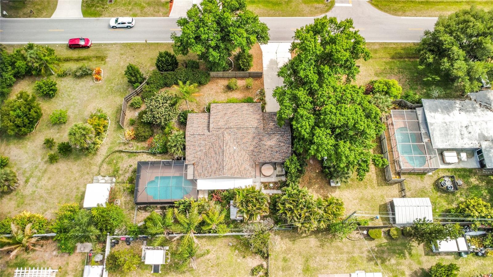 Welcome to this beautifully maintained 2-bedroom, 2-bath pool home in the highly desirable South Venice area, ideally situated on three oversized lots totaling 12,000 SF with two additional adjoining lots available for purchase separately—offering a rare opportunity for extra privacy, expansion, or additional storage space.

Positioned on higher ground than many neighboring homes, this property provides exceptional privacy and room to breathe, enhanced by mature landscaping, strategic fencing, and lush tropical surroundings. The grounds are a true Florida oasis featuring hundreds of plants, shade trees, palms, fruit and flowering trees, succulents, and thoughtfully designed garden islands that create a serene setting for birds and butterflies alike.

Inside, this cozy and well-cared-for home offers 1,330 square feet under air (plus attached air-conditioned garage) and features comfort-focused upgrades throughout, including impact windows, new roof (2024) with transferable warranty, newer HVAC, new hot water heater, new dishwasher, reverse osmosis drinking water system, and whole-house generator hookup.

Step outside to your private backyard retreat featuring a screen-enclosed heated pool, hot tub with new pump/heater, and outdoor enclosed shower—perfect for enjoying Florida living year-round.

Additional highlights include:

Air-conditioned attached garage
Two outbuildings, including powered workshop with A/C
Large concrete driveway with ample parking
Space for RV/boat/recreational vehicle storage
One adjoining lot includes enclosed culvert for vehicle access
Water treatment system and softener included

Located just 1 minute from US-41 and only 10 minutes to Venice Beach, Caspersen Beach, Brohard Park, Sharky’s on the Pier, shopping, dining, and everyday conveniences, this property offers the perfect blend of privacy, accessibility, and Florida lifestyle.

A truly unique opportunity to own a private tropical retreat with expansion potential in one of Venice’s most sought-after areas.