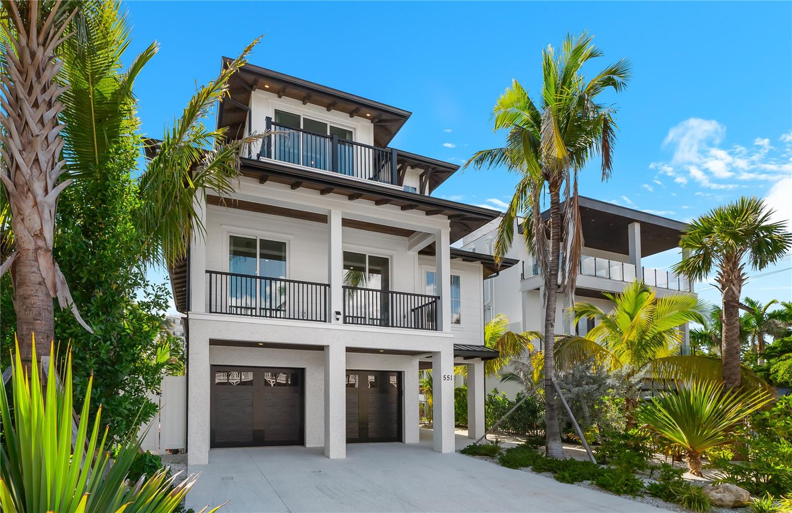 Welcome to Lido Dreams, an exquisite 5,500 square foot luxury retreat nestled in the vibrant heart of St. Armands Circle on Lido Key. This brand-new masterpiece boasts 9 spacious bedrooms and 9 luxurious bathrooms, making it the ideal sanctuary for families or groups seeking both comfort and style. With a private pool, relaxing hot tub, and expansive outdoor living areas, Lido Dreams harmoniously blends modern elegance with the laid-back charm of coastal living.

As you step inside, you’ll be greeted by a grand private foyer that sets the tone for the sophistication that awaits. An elevator and stylish stairway provide seamless access to the main living spaces, ensuring that your experience is as convenient as it is enjoyable. The oversized garage accommodates up to five vehicles, providing ample space for parking and storage, perfect for those who love to explore the surrounding area.

On the second floor, you’ll find the heart of the home, designed for gatherings and celebrations. The spacious living room invites you to unwind, while the bright dining area and chef’s kitchen create a welcoming hub for shared meals and memorable moments. With five beautifully appointed bedrooms on this level, each featuring its own ensuite bathroom, your guests will enjoy the perfect balance of privacy and comfort. A well-equipped butler's pantry and one of two laundry rooms enhance the functionality of this floor, making it as practical as it is luxurious.

Venture to the third floor, where the expansive primary suite offers a private sanctuary. Complete with its own living area, an extra-large bedroom, dual bathroom vanities, and a grand walk-in closet, this suite is designed for relaxation and rejuvenation. Picture yourself enjoying breathtaking views of playful manatees and dolphins from the comfort of your extraordinary owner's suite. Additional bedrooms, each with ensuite baths, ensure that every guest feels at home, with a second laundry room conveniently located on this level for added ease.

Ascending to the rooftop, you will discover an open-air living space that redefines outdoor entertaining. This large rooftop deck invites you to savor morning coffee under the sun, enjoy sunset cocktails with friends, or indulge in stargazing on a clear night. It’s the ultimate backdrop for unforgettable moments, whether you're hosting a gathering or simply soaking in the serene surroundings.

From sunlit gathering spaces to tranquil private retreats, Lido Dreams strikes the perfect balance between togetherness and solitude. Set in an unbeatable location just steps away from shopping, dining, and the pristine beach, this property embodies the essence of luxury living on Lido Key. Currently operating as a successful short-term rental with impressive bookings, Lido Dreams offers not just a home but an opportunity for a thriving investment. Financials are available upon request, making this an enticing prospect for discerning buyers. Don’t miss your chance to own this exceptional piece of paradise! *not pictured: boat dock & deck and outdoor kitchen & shower to be included in asking price.