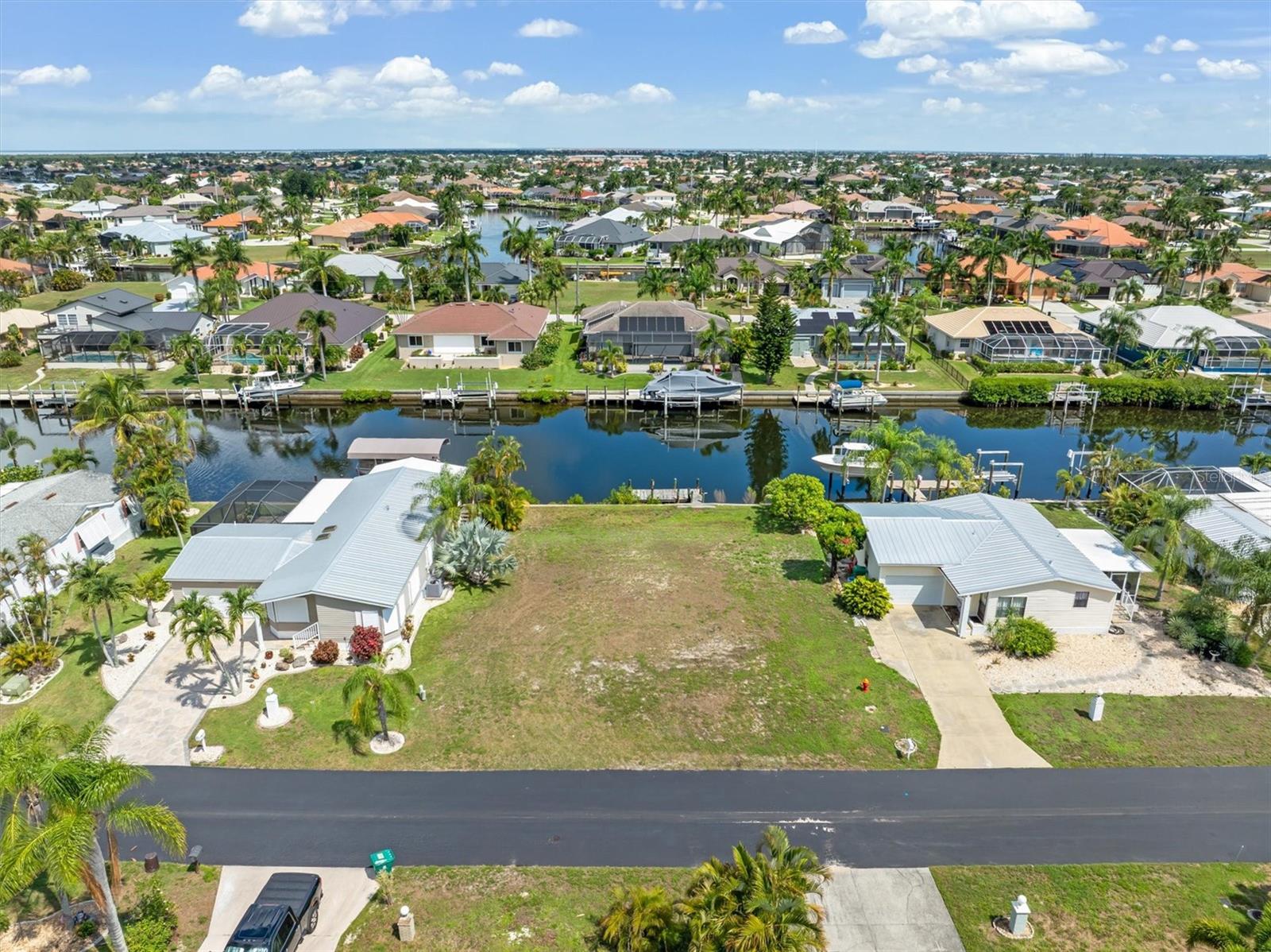RARE WATERFRONT LOT IN "BY THE SEA" COMMUNITY. BOATER'S PARADISE WITH ZERO BRIDGES:
Bring your blueprints and your boat! This premium vacant lot offers 75 feet of prime waterfront already equipped with a sturdy rip-rap seawall and wood dock. Nestled in a unique, private community offering a charming mix of custom stucco homes and pristine, well-groomed manufactured homes, this property gives you the ultimate flexibility to build your dream lifestyle at an unbeatable price.
Boating enthusiasts will love the true sailboat water with absolutely no bridge restrictions. Navigate quickly through Buckley Pass to find yourself in open water in just 5 to 7 minutes.
By Water: Cruise up Alligator Creek for a casual bite at the Riviera Tiki Bar and Grill, or take a short boat ride to the iconic Fishermen's Village to explore boutique shops, diverse restaurants, and the world-class Military Heritage Museum.
By Land: You are just a few minutes' drive from historic downtown Punta Gorda. Enjoy a vibrant local dining scene, weekend farmers markets, boutique shopping, and miles of serene, harbor-front parks.
Whether you want to build a custom coastal home, design a private pool oasis, or just launch your kayaks right from your backyard, this location delivers the perfect blend of high-energy adventure and laid-back Florida relaxation. Invest now at today's price and dream until you choose to retire or buy today and build this year!  Opportunities in this location at this price point are incredibly rare—schedule your viewing today and start living the salt life tomorrow!