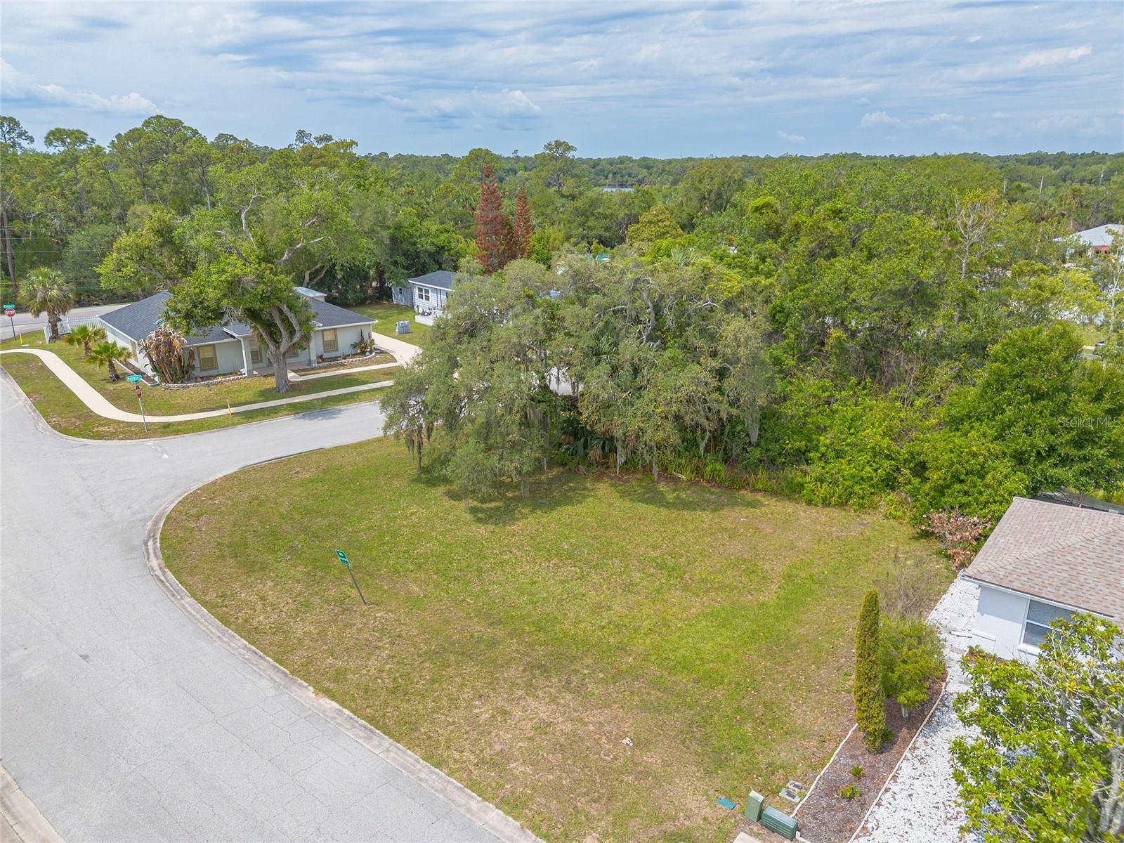 Imagine the possibilities on this idyllic corner lot, perfectly situated in the charming coastal community of New Smyrna Beach. This tranquil neighborhood offers the ideal backdrop for your dream home, just a short drive from pristine beaches, vibrant local shops, and delightful dining experiences.

With convenient access to major roadways, commuting and exploring the area is effortless. Whether you're looking to retire in paradise, invest in your future, or create the ultimate vacation retreat, this parcel of land presents endless potential.

Don’t miss your chance to secure a prime piece of real estate in one of Florida's most sought-after coastal towns. Embrace the lifestyle you've always dreamed of!