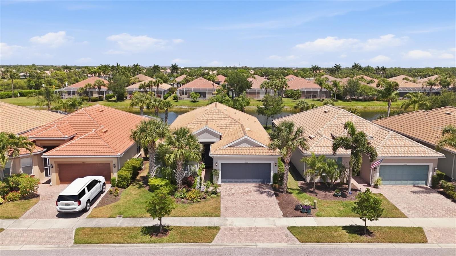 Welcome to IslandWalk at the West Village, a premier resort-style community offering luxury living and picturesque waterfront views. This spectacular Tifton Model waterfront home features 2 bedrooms, 2 bathrooms, and 2 versatile bonus rooms in a desirable split floor plan design.

The open-concept layout seamlessly connects the living room, dining room, and kitchen, creating a spacious great room that opens to an extended screened-in waterfront lanai beautifully enhanced with pavers for added charm and ambiance. The kitchen showcases stunning water views and features a large eat-in island, granite countertops, abundant cabinetry, a spacious pantry, dual sinks, and plenty of workspace for entertaining and everyday living.

The primary suite offers a relaxing retreat with an en-suite bathroom featuring dual sinks, a walk-in shower, private water closet, and a large walk-in closet. Neutral tile flooring laid diagonally flows throughout the main living areas, while plantation shutters add elegance throughout the home. The second bedroom features wood flooring and is conveniently located near the guest bathroom and two bonus rooms, perfect for an office, den, hobby room, or additional guest space.

Additional highlights include a large laundry room complete with folding station and cabinetry, as well as a spacious 2-car garage.

This exceptional home offers the perfect blend of comfort, style, and breathtaking waterfront living, whether enjoyed year-round or seasonally.

Living in IslandWalk provides a true resort-style lifestyle with an abundance of amenities including geothermal pools, lap pools, spas, Har-Tru tennis courts, pickleball, bocce ball, basketball courts, playground, dog park, two state-of-the-art fitness centers, a library, outdoor pavilion with BBQ grills, and a 24-hour staffed gated entrance. The community also features on-site HOA staff available seven days a week to assist residents and guests.

Golf carts are permitted throughout the community and may also be driven throughout Wellen Park when properly registered. Residents enjoy exclusive access through a private back gate to Downtown Wellen Park, featuring a vibrant marketplace anchored by Publix, the Atlanta Braves Spring Training Stadium, restaurants, shopping, and entertainment.

Conveniently located approximately 4 miles from I-75, this home offers easy access to pristine Gulf beaches, airports, Historic Venice Island, dining, shopping, and cultural attractions.

Schedule your private showing today and experience this beautiful waterfront home for yourself.