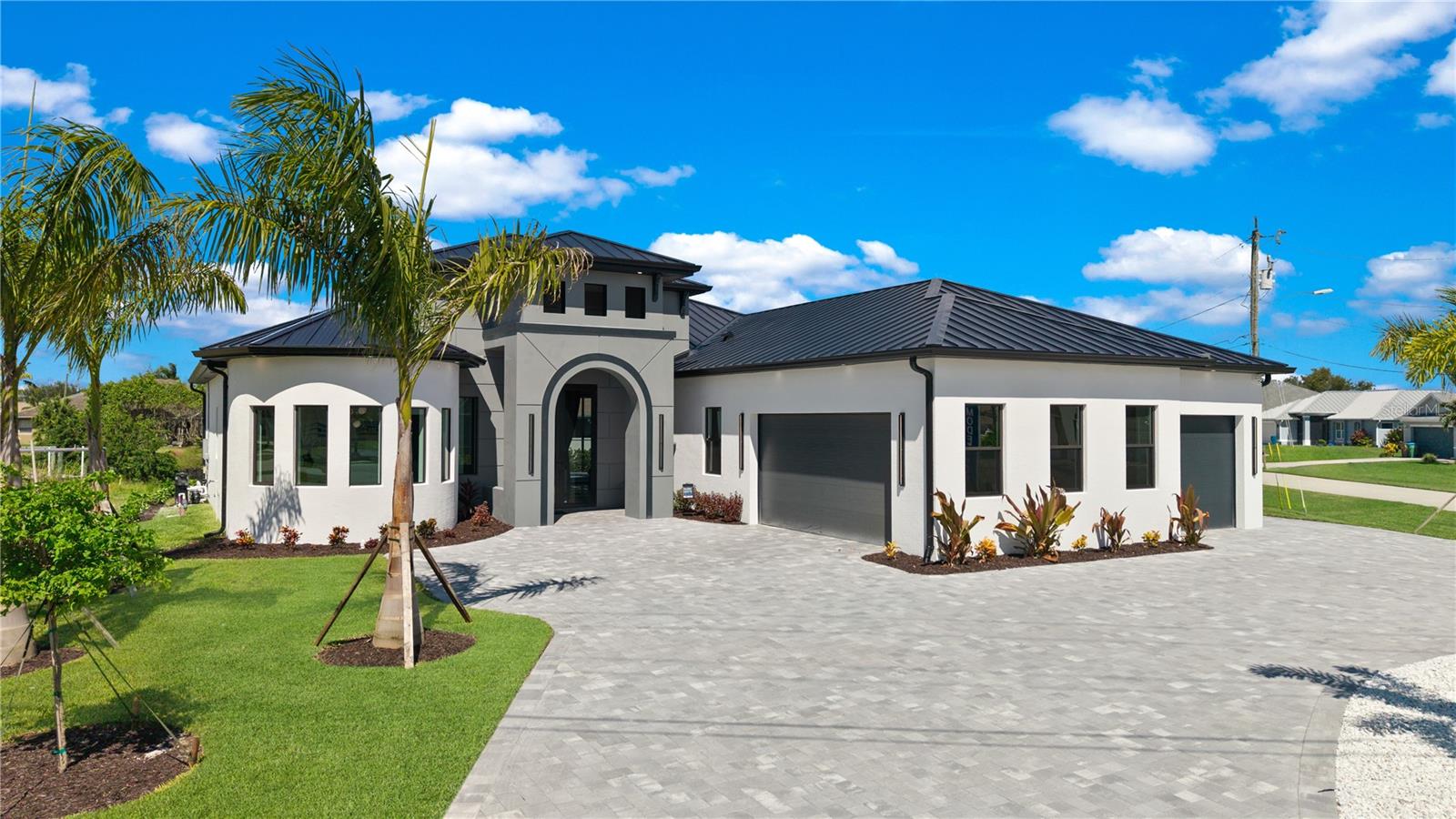 Welcome to 4218 SW 17th Ave – A Stunning Gulf Access New Construction on a triple lot! This gem offers an unforgettable first impression blending luxury with functionality in every corner.

Step through grand 10-ft double glass entry doors into a meticulously designed interior boasting soaring ceilings up to 16.5 ft in the great room and 10-ft glass sliding doors that create a seamless indoor-outdoor flow. A hidden door off the foyer cleverly conceals a private office tucked inside the rotunda, perfect for those working from home or needing a quiet retreat.