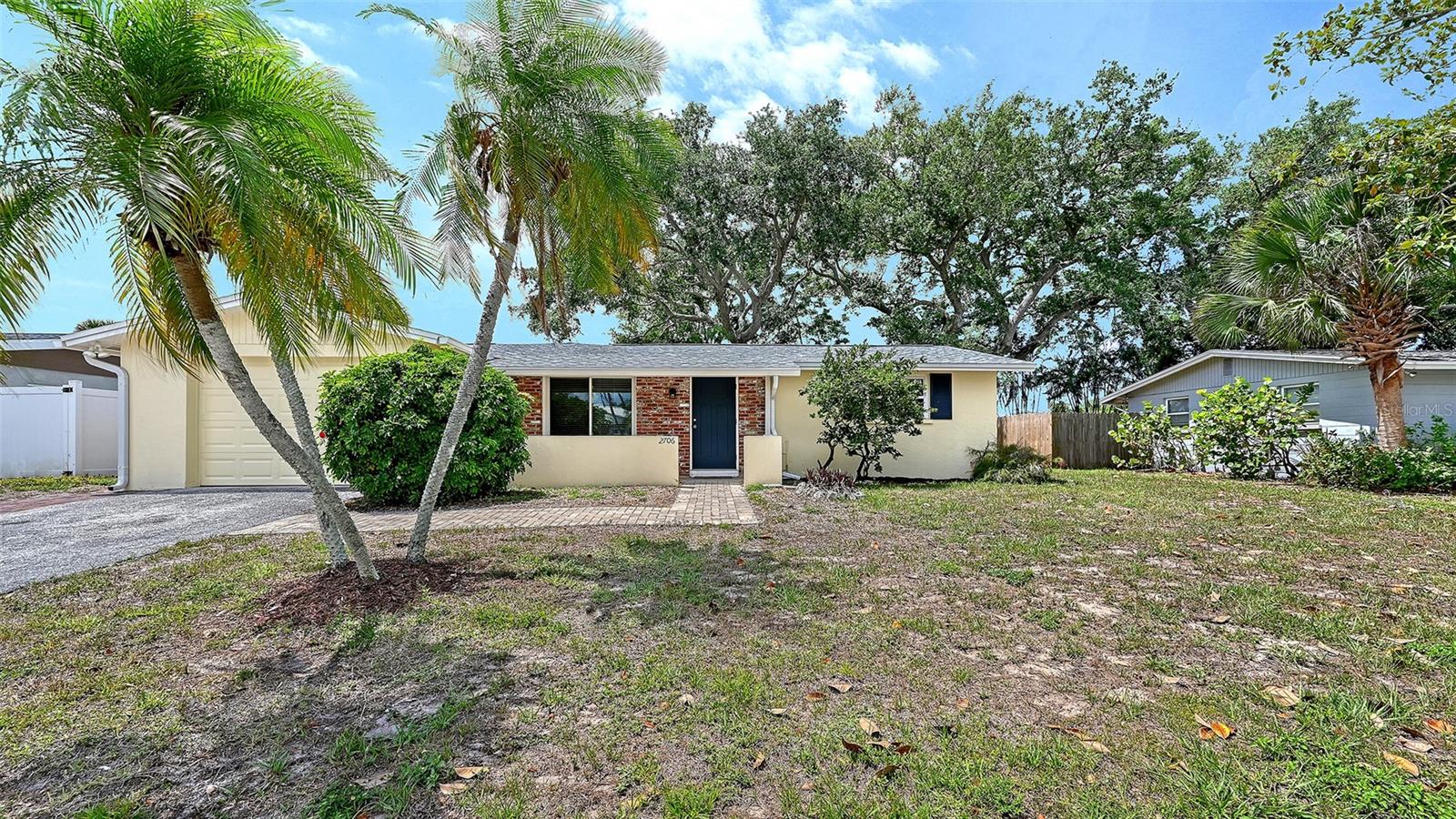 Don't miss your chance to own a beautifully remodeled home in Gulf Gate, one of Sarasota's most sought-after locations. This 1600 Square Foot home on a quiet street is move in ready with nothing to do but sit back & enjoy. As you approach the home along the paver walkway & covered porch, you step through an impact rated door to a modern open-concept layout with elegant new luxury vinyl plank flooring. Large windows in the Living Room flood the room with light, and a wall of windows in the Dining Room brightens every meal. The large updated white kitchen has newer appliances, tile backsplash, and a breakfast bar. Oversized sliding glass door opens to a large backyard deck for entertaining and a paver patio perfect for a firepit and grilling. Mature trees and palms abound and set the tone for relaxing on a private lot with room for a pool. Split floorplan has two bedrooms and a tile bath with a tub down a short hallway from living areas at one end of the home. At the rear of the home, the primary bedroom has a vaulted ceiling with walk-in closet, en-suite updated tile shower, chair height toilet and sliding glass door that opens to the deck. Laundry and storage shelves in 1 car garage. Hot water heater replaced in 2026, Roof in 2025, and the Central Heat & Air (with insulated ductwork) and R-32 Attic Insulation in 2020. Professionally painted inside & out in 2026. Modern 6 panel doors with new hardware, 4 ceiling fans and wide window blinds on replacement double pane windows throughout. Lovingly owned and updated by long term owners. Great schools, shopping, and Gulf Gate Village restaurants within easy walking distance. Area beaches, churches, and vibrant arts and culture a short drive away.