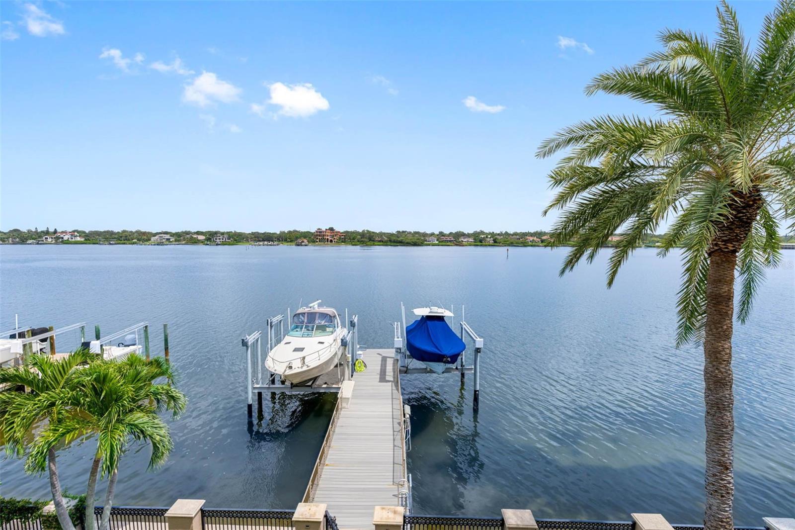 Coastal Elegance Meets Effortless Living in Indian Rocks Beach - Welcome to your slice of paradise—where Mediterranean charm meets the tranquil beauty of Florida’s Gulf Coast. This exceptional waterfront retreat is tucked away in the heart of Indian Rocks Beach, a vibrant yet laid-back coastal town known for its warm sense of community and colorful mix of homes, shops, and local eateries. From the moment you step inside, you’re greeted by a kitchen designed to inspire—from rich custom wood cabinetry and granite countertops to high-end appliances and a generous butler’s pantry with its own coffee bar and wine fridge. Whether you're preparing an intimate dinner or hosting friends, the ambiance flows easily into the spacious great room, where French doors lead to a breezy balcony made for entertaining, complete with an outdoor grill and cozy fireplace. A stunning curved staircase leads you upstairs to the primary suite—your private sanctuary. Enjoy peaceful mornings on your balcony overlooking the water and unwind in a spa-like bath that features dual vanities and an oversized walk-in shower. A second private suite is perfectly positioned on its own level, while two additional bedrooms share a Jack-and-Jill bath, creating a comfortable and connected space for family or guests. Downstairs, a separate guest area includes its own bedroom, full bath, and living space—ideal for a mother-in-law suite or private rental potential, with room to add a kitchenette for full independence. Step outside and feel like you’re on vacation every day. The sparkling pool and spa are framed by low-maintenance turf and a serene patio with pavers that look out onto the intracoastal waterway. Your own private dock invites you to explore the open waters by boat or simply enjoy a sunset cocktail with your feet dangling just above the tide. With an oversized garage upgraded with an epoxy floor and built-in storage, this home has space for all your beach toys—and then some. And when you're ready to venture out, hop on your bike or golf cart to explore local festivals, waterfront dining, and the sugar-white sands just moments away. This isn’t just a home. It’s a lifestyle—where every detail whispers relaxation, and every day feels inspired. Come see where the charm of Tuscany meets the beauty of Tampa Bay.