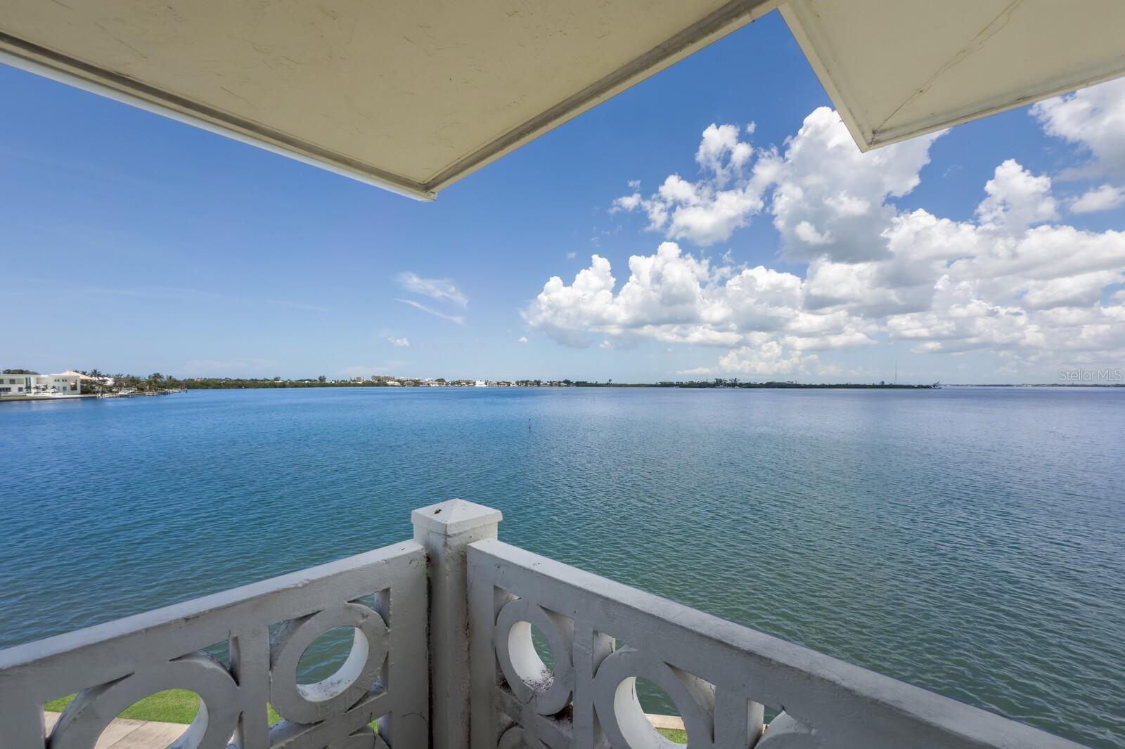 ONLY DIRECT WATERFRONT END UNIT AVAILABLE IN THE COMMUNITY. Double the windows.  Double the views. Exquisite FURNISHED interior designer owned condo epitomizing refined coastal living in Sarasota and completely renovated in 2019-2020. Interiors are enveloped in a meticulous pallet of ocean-inspired hues that blends timeless style with modern functionality and coastal glam charm. Professionally envisioned by this talented designer/owner and masterfully executed by a long-standing, local, luxury builder with no expense spared. Entirely new infrastructure, including complete drywall replacement, floors, and raised ceilings, new HVAC and ductwork, in-wall sound insulation, double insulated attic, new electrical panel including wiring in walls, all new plumbing throughout, new 40-gallon water heater, and more. This unit is ultimate storm ready including PGT impact windows and doors and withstood the unprecedented 2024 storm season with incredible resilience and zero damage. The thoughtfully crafted kitchen features only the best of Miele, Sub-Zero and Viking appliances, Waterstone fixtures that shine beneath bespoke lighting, an artist commissioned mosaic, and a hand-forged range hood. A large under-lit quartzite island can seat 6, bench built solid wood Albrecht cabinetry with pullouts, under cabinet outlets, paneled appliances, Cambria 6cm custom profile back countertops, and grout-less sea glass backsplash ensure any chef a seamless experience. The magic is in the details and this unit is a work of art unto itself but within you will find a curated collection of salvaged nautical antique accents from across the world, artwork paying homage to Sarasota’s history, an authentic nautical porthole from a German ship, and master carpentry features such as tongue and groove ceilings, solid wood doors, shiplap accents, 7” stacked crown moldings, 5” baseboards, plantation shutters, and built ins with color changing Dimplex fireplace. The excellence does not stop here...every room includes recessed gimbal lighting with Maestro dimmers, the spa-inspired bathrooms glimmer with custom tile work, hammered nickel sinks, a seamless glass shower, Rohl polished nickel fixtures, hotel double towel racks, heat lamps, Helios LED smart mirrors, and other luxe finishes. Besides the unbeatable location, residents of Sarasota Harbor West enjoy an array of inclusive amenities that include a large heated waterfront pool, clubhouse, shuffleboard, fishing pier, and grill areas. End unit balconies can be screened-in with HOA design approval. Non-deeded boat slips are available for a very small fee on a first-come basis. Less than one block to St. Armand’s Circle and a short jaunt from the beach, parks, wildlife centers, 3 yacht & sailing clubs, downtown, The Ritz Carlton, The St. Regis, and a plethora of boutique shops and restaurants. Enjoy breathtaking sunset & turquoise water views from every room over Sarasota Bay and beyond to the Keys. Watching dolphins play and manatees swim along the seawall below your balcony will be a daily occurrence. A more well positioned unit does not exist in Sarasota Harbor (top floor, end unit, Western facing, closest to the water, and closest building to the circle).