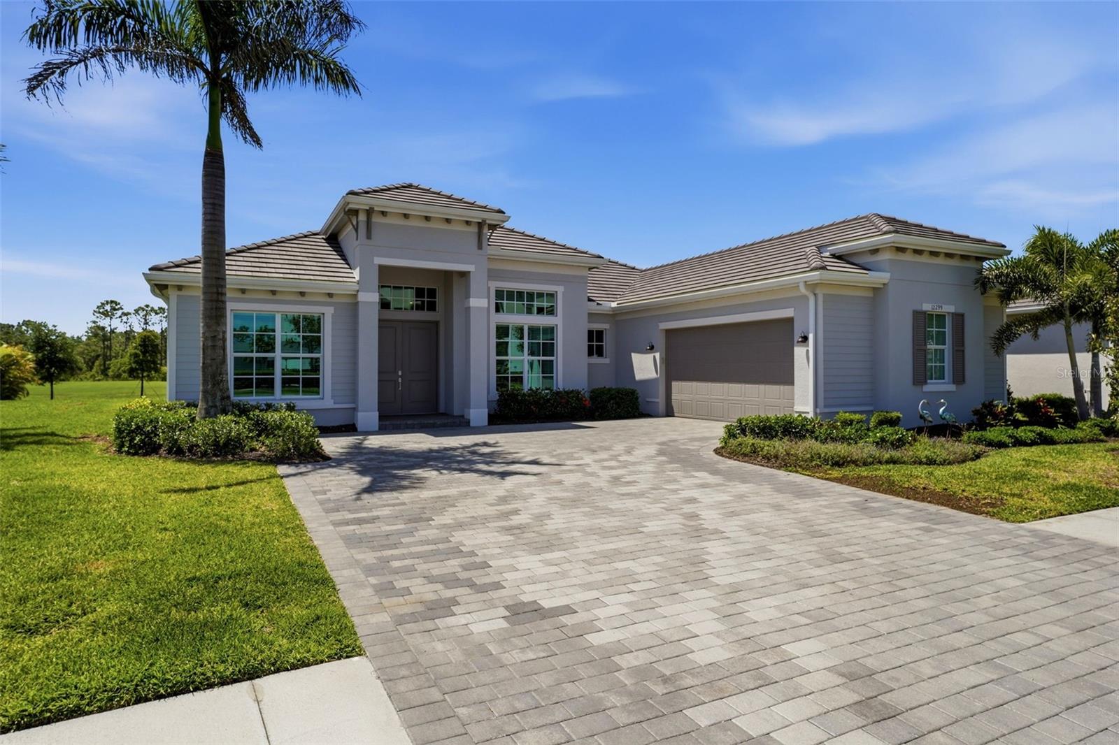Step into a lifestyle of uncompromising luxury at this stunning golf-deeded estate within Wellen Park Golf & Country Club! Positioned on the 18th fairway, this meticulously designed 4-bedroom, 3-bathroom Bougainvillea II residence serves as a masterclass in Florida indoor-outdoor living. The heart of the home is an expansive, light-filled open concept that seamlessly integrates the chef’s kitchen—complete with quartz surfaces and premium stainless appliances—with a grand living area framed by panoramic views. Retreat to the primary sanctuary, featuring dual walk-in closets and direct, private access to the lanai, while guests enjoy ultimate seclusion in two thoughtfully placed en-suites. The outdoor retreat is the true crown jewel. Spend your afternoons in the custom heated salt-water pool or spa, overlooking sweeping water and fairway vistas. The professional-grade outdoor kitchen is an entertainer’s dream, outfitted with a built-in grill, double-drawer refrigeration, and a 2-tap kegerator. As the sun sets, vibrant LED lighting sets the mood, and electric hurricane screens offer effortless protection and privacy at the touch of a button. From the championship golf course and Tiki Bar to the upcoming state-of-the-art Clubhouse, every resort amenity is at your fingertips. Resort-style pool and spa, fitness center, tennis and pickleball courts, bocce ball courts, a dog park, and a social calendar with clubs, events, and activities for all to enjoy. Ideally located near downtown Wellen Park, shopping, dining, and beautiful Gulf beaches. Discover the pinnacle of Wellen Park living. Schedule your private showing today!