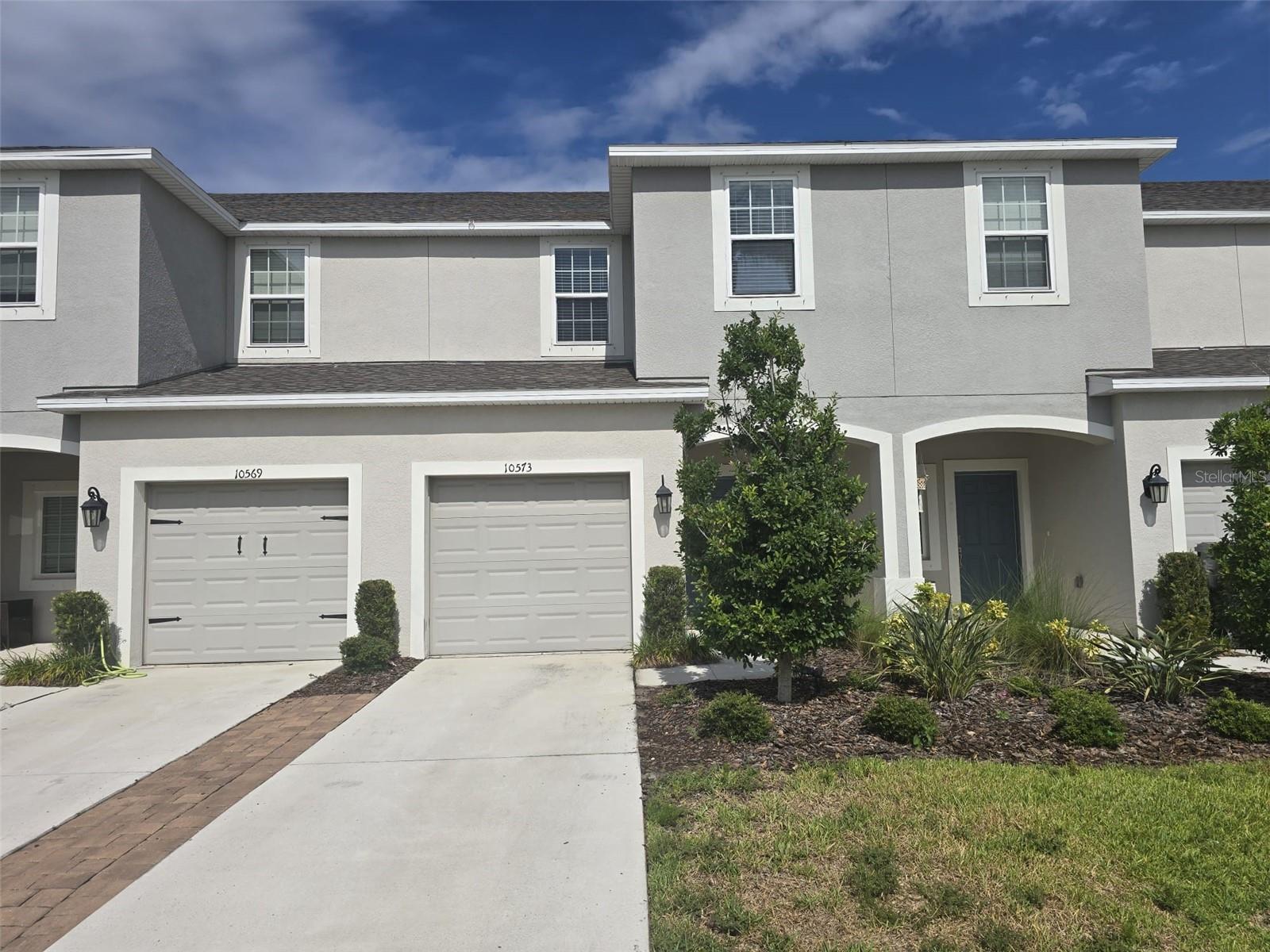 **Welcome to 10573 Oakside Drive in the sought-after Artisan Lakes community of Palmetto!** Built in 2022, this beautifully maintained two-story townhome offers 3 bedrooms, 2.5 bathrooms, and approximately 1,407 square feet of thoughtfully designed living space.

Step inside to discover an open-concept floor plan featuring durable tile and luxury vinyl flooring throughout—completely carpet-free for easy maintenance. The spacious living and dining areas flow seamlessly into the modern kitchen, complete with a large center island, ample cabinetry, and plenty of counter space, making it ideal for everyday living and entertaining.

Upstairs, the private owner's suite features a generous walk-in closet and an en-suite bath with dual vanities. Two additional bedrooms, a full bathroom, and a conveniently located second-floor laundry area provide comfort and functionality for family or guests.

Enjoy outdoor living on the private patio, perfect for relaxing or grilling, while the attached one-car garage offers added storage and convenience.

Located in the desirable Artisan Lakes community, residents enjoy resort-style amenities, including a community pool, clubhouse, scenic walking trails, and beautifully landscaped common areas. With easy access to I-75, shopping, dining, schools, and the Gulf Coast's stunning beaches, this move-in-ready home offers the perfect blend of comfort, style, and convenience.

Don't miss this opportunity to own a modern, low-maintenance townhome in one of Palmetto's most desirable communities.