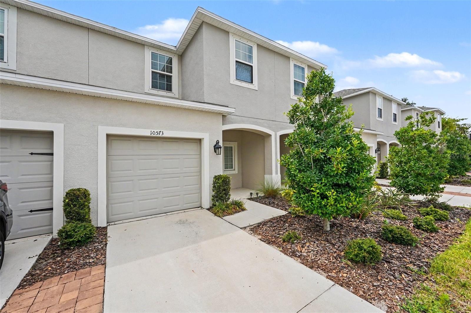 Virtually Staged. **Welcome to 10573 Oakside Drive in the sought-after Artisan Lakes community of Palmetto!** Built in 2022, this beautifully maintained two-story townhome offers 3 bedrooms, 2.5 bathrooms, and approximately 1,407 square feet of thoughtfully designed living space.

Step inside to discover an open-concept floor plan featuring durable tile and luxury vinyl flooring throughout—completely carpet-free for easy maintenance. The spacious living and dining areas flow seamlessly into the modern kitchen, complete with a large center island, ample cabinetry, and plenty of counter space, making it ideal for everyday living and entertaining.

Upstairs, the private owner's suite features a generous walk-in closet and an en-suite bath with dual vanities. Two additional bedrooms, a full bathroom, and a conveniently located second-floor laundry area provide comfort and functionality for family or guests.

Enjoy outdoor living on the private patio, perfect for relaxing or grilling, while the attached one-car garage offers added storage and convenience.

Located in the desirable Artisan Lakes community, residents enjoy resort-style amenities, including a community pool, clubhouse, scenic walking trails, and beautifully landscaped common areas. With easy access to I-75, shopping, dining, schools, and the Gulf Coast's stunning beaches, this move-in-ready home offers the perfect blend of comfort, style, and convenience.

Don't miss this opportunity to own a modern, low-maintenance townhome in one of Palmetto's most desirable communities.