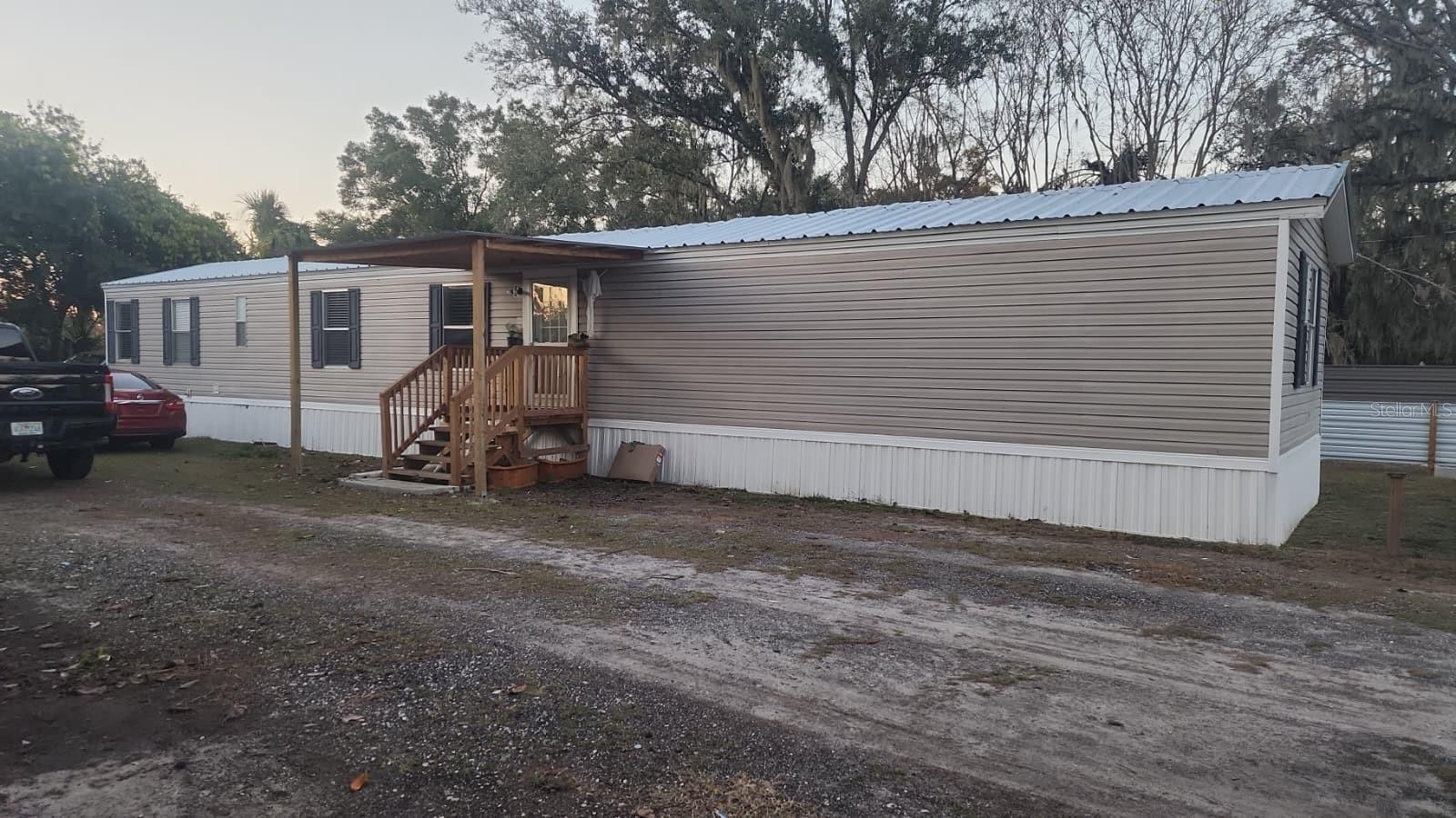 ONLY CASH. Financing is not accepted—cash only—because the mobile home has been moved from its original location. Discover this incredible opportunity! This property sits on 0.26 acres of privately owned land and features a 2005 manufactured home, fully renovated and move-in ready. It offers the space and peace you’re looking for, combined with modern upgrades and a fresh, stylish design. The home includes a brand- new 2025 AC, 2025 septic tank, 2025 well, and a metal roof, providing durability and efficiency for years to come. Inside, you’ll find a completely updated interior with a modern kitchen, renovated bathrooms, updated flooring, and a clean, contemporary look. The home offers 3 bedrooms, 2 bathrooms, a laundry area, and a comfortable, functional layout. Need outdoor space? You’ve got it. The large lot provides plenty of room to park boats, trucks, large vehicles, and even includes water and sewer hookups for an RV—perfect for guests, extra income, or personal convenience. Conveniently located with easy access to major interstates, schools, and shopping centers, this property brings together location, value, and modern living. Don’t miss the chance to own this beautifully updated home!