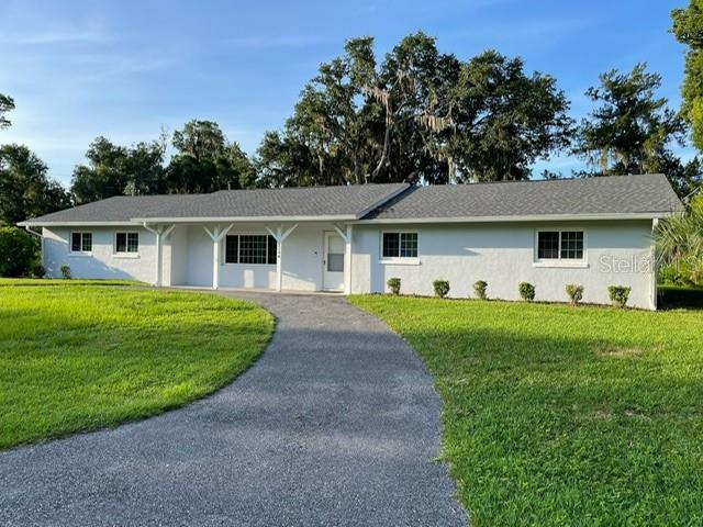 COMPLETELY REMODELED 3 BEDROOM IN PRIME LOCATION!!!!  Immaculate and move in ready gorgeous home on quiet street with huge corner lot.  This beautiful home offers a living room and family room with fireplace, completed enclosed lanai and very large 2 car garage.  The bedrooms are spacious with the large primary having an ensuite full bathroom and 2 closets.  The additional 2 guest bedrooms share a large bathroom immediately opposite hallway.  High ceilings and open floor plan give a bright and spacious space ready for a family.  Bring your vehicles and toys with so much parking!! Circular drive in front of house and separate parking by the garage hidden from the road.  Bring your pets with the grassy backyard that is currently partially fenced. Located just minutes from downtown Ocala, hospitals, schools and restaurants make this property a perfect home for professionals or family while it also is a great investment and proven income producing rental.  
THIS PROPERTY IS A MUST SEE in person it is completely turn key and impeccable.