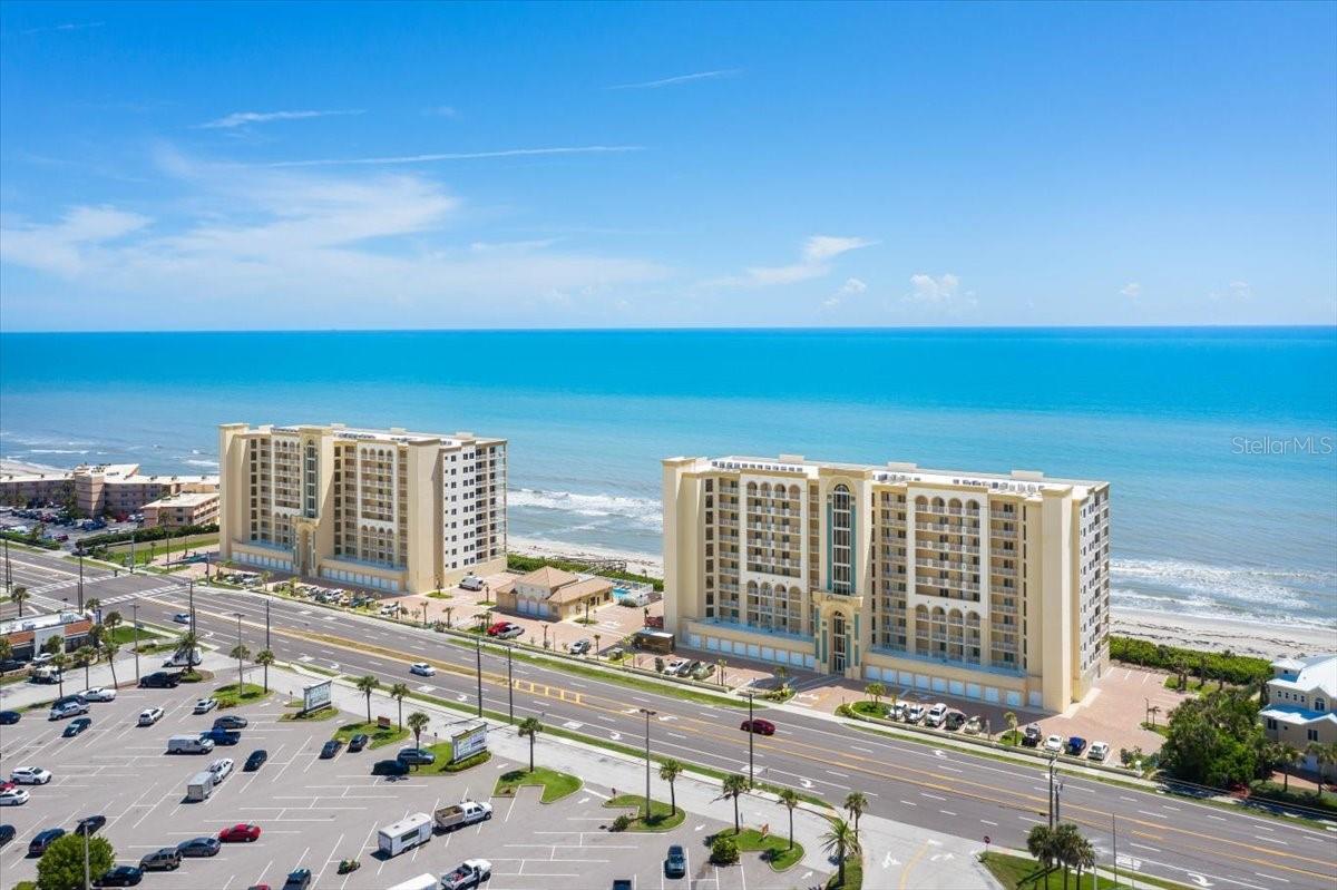 Paradise awaits you at the newest luxury condos in Satellite Beach. This 3 bed/3 bath direct oceanfront unit has a wraparound balcony which will have you mesmerized! Upgraded tile, granite and cabinets throughout the condo gives you the complete modern feel. Chef's kitchen with stainless steel appliance, center island, and plenty of space to cook and entertain. Very Open concept with 9 ft ceilings. Owner has added many upgrades with plantation shutters and electric blinds throughout the unit, custom bedroom cabinets with a Murphy bed in the 2nd bedroom, custom built in entertainment center, additional cabinets over the washer/dryer, and extended cabinets with granite in kitchen. There is one reserved parking spaces under-building, and plenty of parking in front of the building as well.