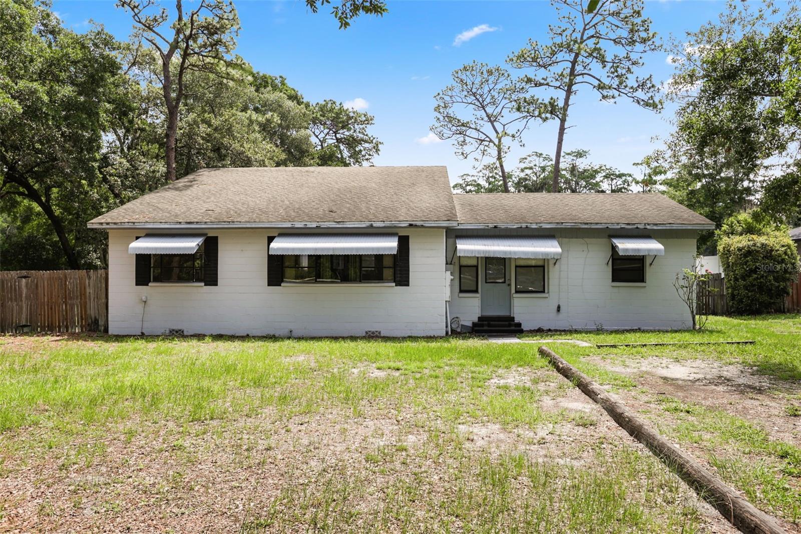 Rare opportunity to own a lakefront property in a convenient central location. This 3-bedroom, 2-bath home features a desirable split-bedroom floor plan, vaulted ceilings, and an open-concept layout with the kitchen overlooking the family room, creating a bright and functional living space. Enjoy direct access to a chain of lakes and beautiful water views from your own property. Additional features include a rear carport/workshop offering flexible space for storage, hobbies, or projects. No HOA. New sidewalks are being added along the front of the property, enhancing accessibility and streetscape appeal.
