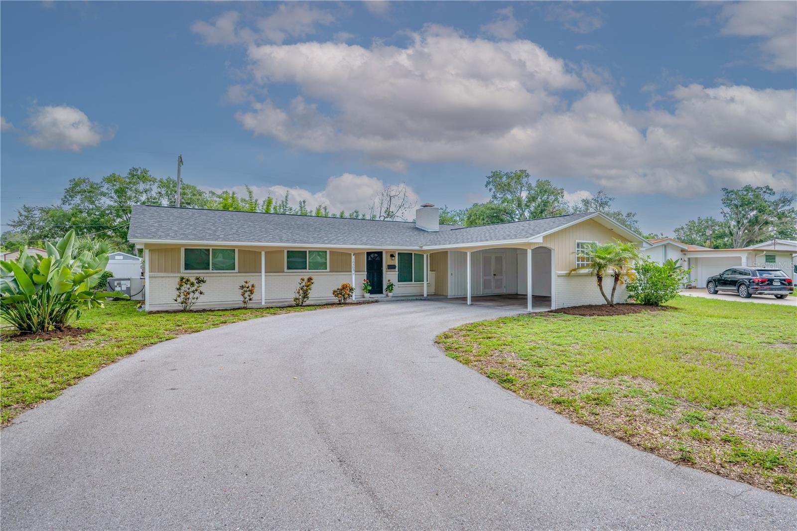 Virtually Staged. Enjoy lake access, boating, fishing, parks and recreation from this charming 3-bedroom, 2-bath home located in the highly desirable Original Carrollwood community. Residents enjoy access to the Carrollwood Recreation District amenities, including Lake Carroll and its community boat ramp, parks, recreation facilities and tennis courts. The home is also conveniently located near Carrollwood K-8, shopping, dining and everyday conveniences.

Inside, the welcoming family room features a wood-burning fireplace and abundant natural light. The open layout flows into the spacious dining area and updated kitchen featuring white cabinetry, a custom island with additional storage and breakfast-bar seating, butcher-block countertops, stainless steel appliances, an apron-front double sink and upgraded fixtures and hardware. French doors open to the large fenced backyard, while sliding doors lead to the open lanai—creating plenty of space for entertaining, pets and outdoor living.

Terrazzo flooring extends throughout the main living areas and bedrooms, adding character and durability. The oversized laundry room also provides flexible space for a home office, storage or additional household needs. Major improvements include a new roof and air-conditioning system installed in 2022, impact-rated front windows added in 2019, and completely new air-conditioning ductwork installed in 2026. The spacious backyard also includes a newer storage shed.

A wonderful opportunity to enjoy the established neighborhood, recreational amenities and sought-after lifestyle that make Original Carrollwood such a special place to call home.