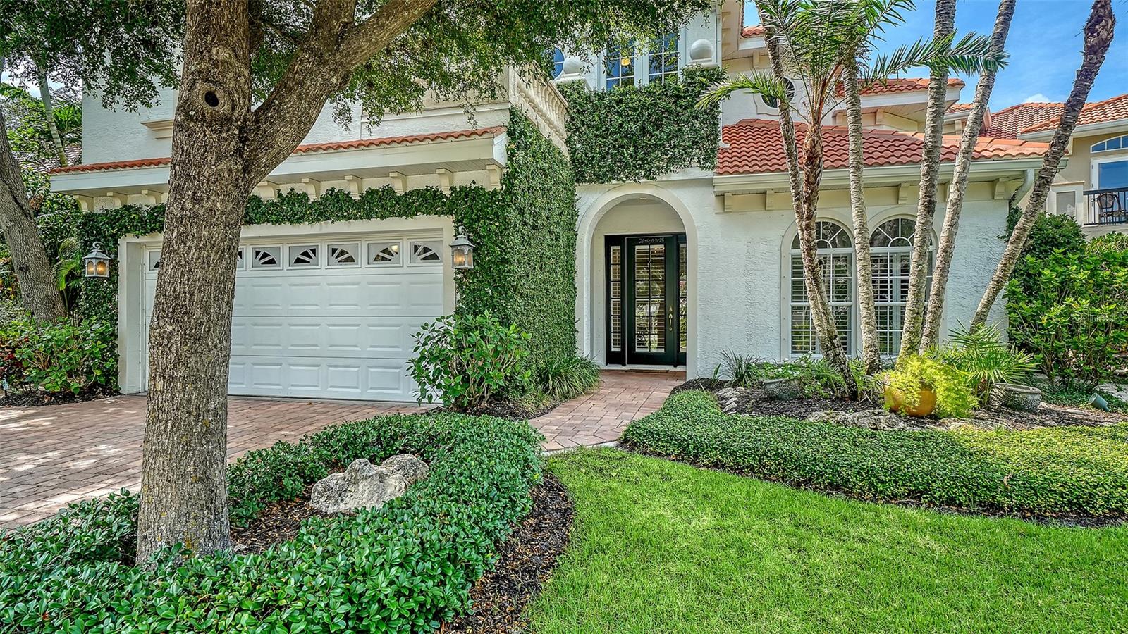 Virtually Staged. Nestled on one of the most picturesque oak-lined streets in Sarasota's highly sought-after Granada neighborhood, this beautifully updated residence offers the perfect blend of elegance, privacy, and effortless Florida living. Surrounded by lush tropical landscaping and a fully fenced yard, the home lives like a maintenance-free property while providing the space, comfort, and independence of a private single-family residence.

Inside, timeless finishes and thoughtful updates create a warm, inviting atmosphere. Engineered wood flooring, crown molding, plantation shutters, custom millwork, and built-in cabinetry enhance the home's sophisticated design, while fresh interior paint (May 2026), updated living room built-ins and trim (2025), and exterior landscape lighting add to its exceptional appeal.

The stunning kitchen, remodeled in 2023, is designed for both everyday living and entertaining. Featuring quartz countertops, an oversized island with seating for six, and premium Sub-Zero, Thermador, and Bosch appliances—including a new cooktop (2025) and dishwasher (2024)—it flows seamlessly into the separate dining room and spacious great room with tray ceiling and custom built-ins. French doors from both living spaces open to the private pool and patio, creating the ideal indoor-outdoor lifestyle.

Upstairs, three generously sized bedrooms and two full baths provide comfortable accommodations for family and guests. On the main level, a versatile den and beautifully remodeled powder bath (2023) offer the perfect space for a home office, media room, or flex living area.

Step outside to your own private backyard oasis featuring a sparkling pool, mature landscaping, and multiple areas for relaxing or entertaining in complete privacy. Whether hosting friends or enjoying a quiet evening at home, this outdoor retreat is designed to embrace Florida's year-round sunshine.

This home has been meticulously maintained with significant recent improvements, including two newer HVAC systems (both replaced within the last three years), a tankless water heater (2020), washer and dryer (2023), hurricane-impact windows and doors with additional hurricane shutters, a DeHart security system, and wiring and plumbing already in place for a future generator.

Perfectly located just minutes from Red Rock Park, Southside Village's boutique shopping and dining, Sarasota Bay, downtown Sarasota, and the world-famous beaches of Siesta Key, this exceptional property offers the rare combination of privacy, luxury, and convenience in one of Sarasota's most desirable neighborhoods.

Experience the best of Sarasota living in a home where timeless style, modern updates, and an unbeatable location come together beautifully.