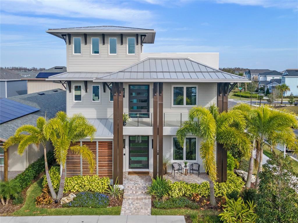 Welcome to the 2022 New American Home in Lake Nona: A Fusion of Style, Luxury & Cutting-edge Technology. Step inside this Miami Deco-inspired haven – a seamless blend of innovative design, advanced technology, and expansive living areas. This 4,674 sq ft residence in Lake Nona, features three opulent bedrooms, four full and three half bathrooms, a home office, dual living spaces, and two laundry rooms, exemplifying the apex of contemporary living.

Elevate your living experience with an additional 8,059 sq ft of comprehensive living space, incorporating an outdoor living room with a summer kitchen, a revitalizing courtyard pool flanked by two StruXure Cabanas, a second-floor balcony, and a spacious third-floor terrace.

Indulge in culinary excellence in our open-plan gourmet kitchen. Furnished with Wellborn Aspire's frameless cabinetry, smart storage solutions, and a large island featuring top-tier quartz countertops and cushion-close doors and drawers. This kitchen showcases the latest Signature Kitchen Suite Appliance Package, facilitating a first-rate cooking experience.

Relish in the luxury of the primary suite, equipped with a morning bar, a walk-in closet with built-in systems, and a state-of-the-art Kohler digital shower system. Each element of this suite, from the quartz countertops and Kohler faucets to the exclusive Air-Jet Shower Drying System in the walk-in shower, exudes elegance.

Every bedroom in this Lake Nona residence is fitted with large closets and private ensuite bathrooms, guaranteeing maximum comfort and privacy. For detailed information on the home's extensive features and green certifications, consult our feature sheet.

Book a tour today to witness the allure of the 2022 New American Home in Lake Nona, an exceptional amalgamation of style, technology, and luxury.