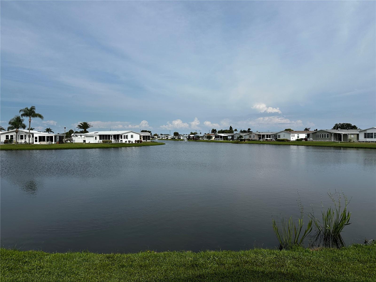 Spectacular waterfront setting with one of the best water views in all of Harbor Isles! Enjoy relaxing mornings and breathtaking sunsets from the spacious Florida Room overlooking the serene lakefront scenery. This home offers an inviting open living and dining area, a bright kitchen with adjoining dinette space, and the convenience of interior laundry. The large primary suite provides a comfortable retreat with ample space and privacy. Located in the sought-after 55+ land-owned community of Harbor Isles, residents enjoy resort-style amenities including marina access, clubhouse, pools, fitness center, pickleball, tennis, and an active social calendar. A rare opportunity to own a home with truly exceptional waterfront views in one of North Port’s premier communities!