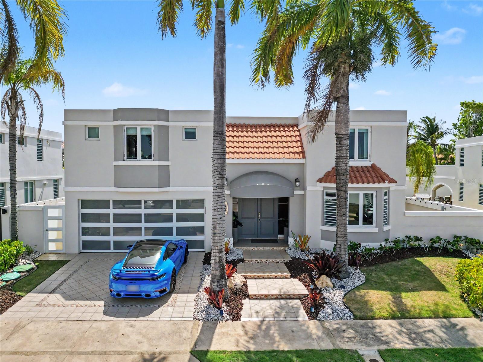 Experience luxury living in the highly sought-after gated community of Paseo Los Corales I in Dorado. This beautifully updated two-story residence offers approximately 3,150 square feet of living space on a 6,400-square-foot lot and features 5 bedrooms, 3 full bathrooms, 1 half bath, and a 2-car garage. The flexible first-floor bedroom is ideal for guests, a home office, or a gym.

The remodeled kitchen showcases brand-new GE appliances, a Samsung refrigerator, wine refrigerator, walk-in pantry, and abundant storage, flowing seamlessly into the spacious living and dining areas designed for everyday comfort and entertaining.

The outdoor living space is a true highlight, featuring a covered terrace, outdoor bar with sink, built-in BBQ, TV, resort-style pool, and jacuzzi, creating the perfect setting for year-round gatherings.

Upstairs, the expansive primary suite offers a private balcony, oversized walk-in closet, and spa-inspired en-suite bathroom with a soaking jacuzzi tub. An expansive rooftop terrace overlooks Dorado Beach and backs directly to Dorado Beach East, offering exceptional views and endless possibilities for outdoor enjoyment.

Designed for comfort and peace of mind, the home includes a 2025 solar energy system with Tesla Powerwall battery storage, professionally sealed roof (2025), impact-resistant windows and glass, full power generator, 600-gallon cistern, laundry room, and multiple storage areas. The solar system contributes to exceptionally low electricity costs.

Residents enjoy 24-hour security within this double-gated community, along with resort-style amenities including a swimming pool, fitness center, basketball court, tennis and pickleball courts, gazebo, and kids playground. Ideally located just minutes from Dorado Beach, restaurants, schools, shopping, and world-class golf.