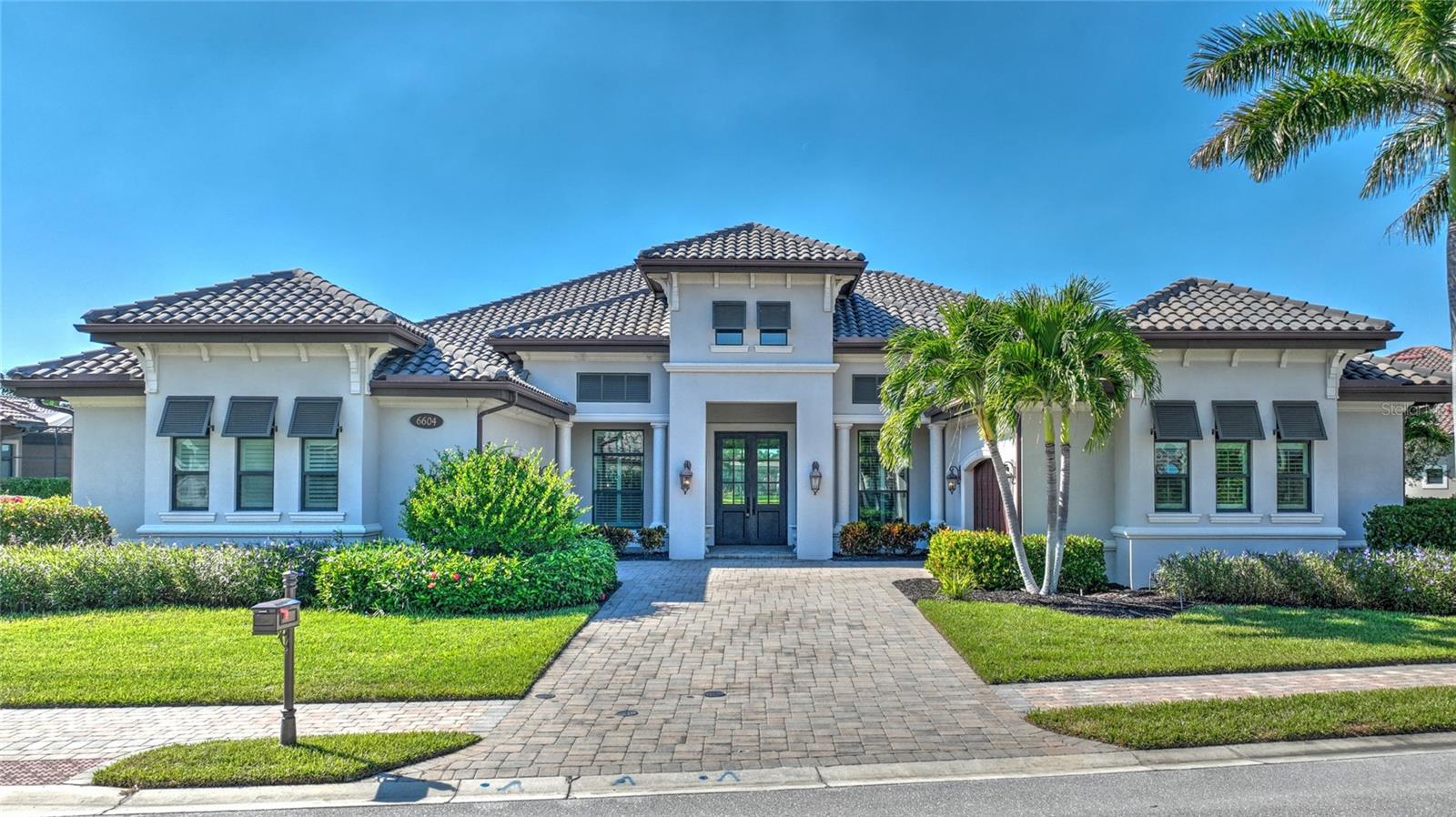 A rare opportunity to own a Windsor model in the popular Lakoya community. This beautifully designed home features a 4-car garage, hurricane shutters, a whole-house generator, an exercise room, and a den. The indoor and outdoor living spaces are connected by sliding pocket doors in the great room, opening to a spacious pool and lanai area perfect for entertaining. The area includes stunning water fountain views, a gas fireplace, and a summer kitchen with a bar. The oversized, gas-heated salt pool with sun shelf and 6-person spa is just steps from the master suite. The Players Club & Spa offers a tropical retreat where you can relax, socialize, and dine. Enjoy swimming, tennis, racquetball, bocce, and a variety of other events year-round! Don’t miss this chance to own a custom home in Lely Resort, Naples.