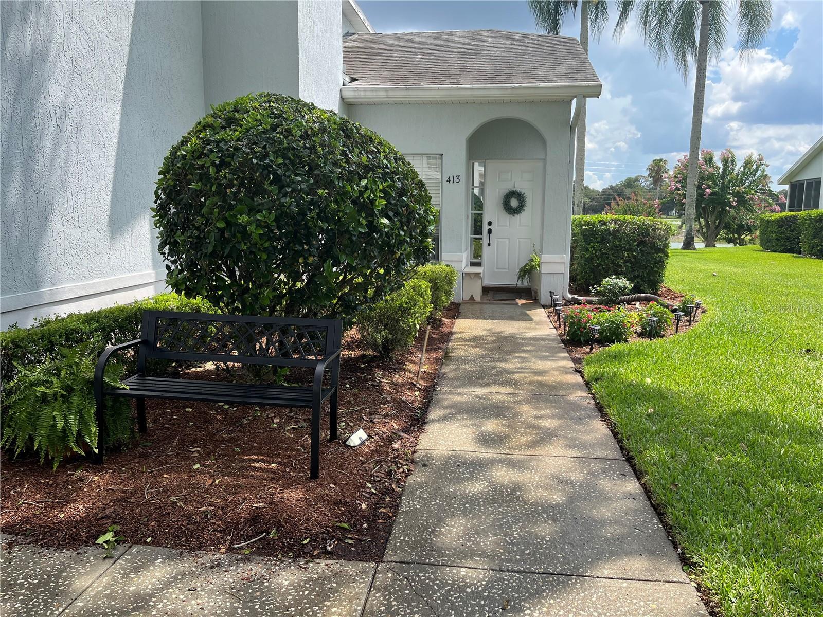 Welcome home to this beautifully maintained one-story condo, perfectly situated on a quiet cul-de-sac within a desirable guard-gated community. Enjoy peaceful pond and golf course views and abundant Florida wildlife while relaxing in the comfort of your own private retreat. The open floor plan features soaring ceilings and luxury vinyl flooring throughout, creating a bright, spacious, and modern living environment. A whole-home water filtration system adds comfort and convenience. The fully enclosed lanai, accessible through sliding glass doors, provides valuable additional living space and is ideal for a sunroom, home office, or entertaining guests. Just beyond the lanai, an open patio offers the perfect spot to enjoy Florida's beautiful weather and tranquil water and golf course views. This home features two generously sized bedrooms and two full bathrooms. The secondary bedroom offers ample closet space and is conveniently located across the hall from the guest bathroom, complete with a tub and shower combination. The oversized primary suite includes a spacious walk-in closet and a private en-suite bathroom featuring dual sinks, a dedicated vanity area, and a walk-in shower. Additional features include a one-car garage with laundry hookups and plenty of storage space. The monthly condo fee covers lawn care, grounds maintenance, and access to the community pool, providing a truly low-maintenance lifestyle. Experience resort-style living with an 18-hole golf course and a community restaurant, all conveniently located within this desirable gated community. This home is conveniently located near shopping, dining, and entertainment, you'll enjoy easy access to the new Sam's Club, Publix, Walmart, and Central Florida's world-famous theme parks. This exceptional condo offers the perfect blend of comfort, convenience, scenic surroundings, and carefree Florida living. *More Photos Coming Soon!*