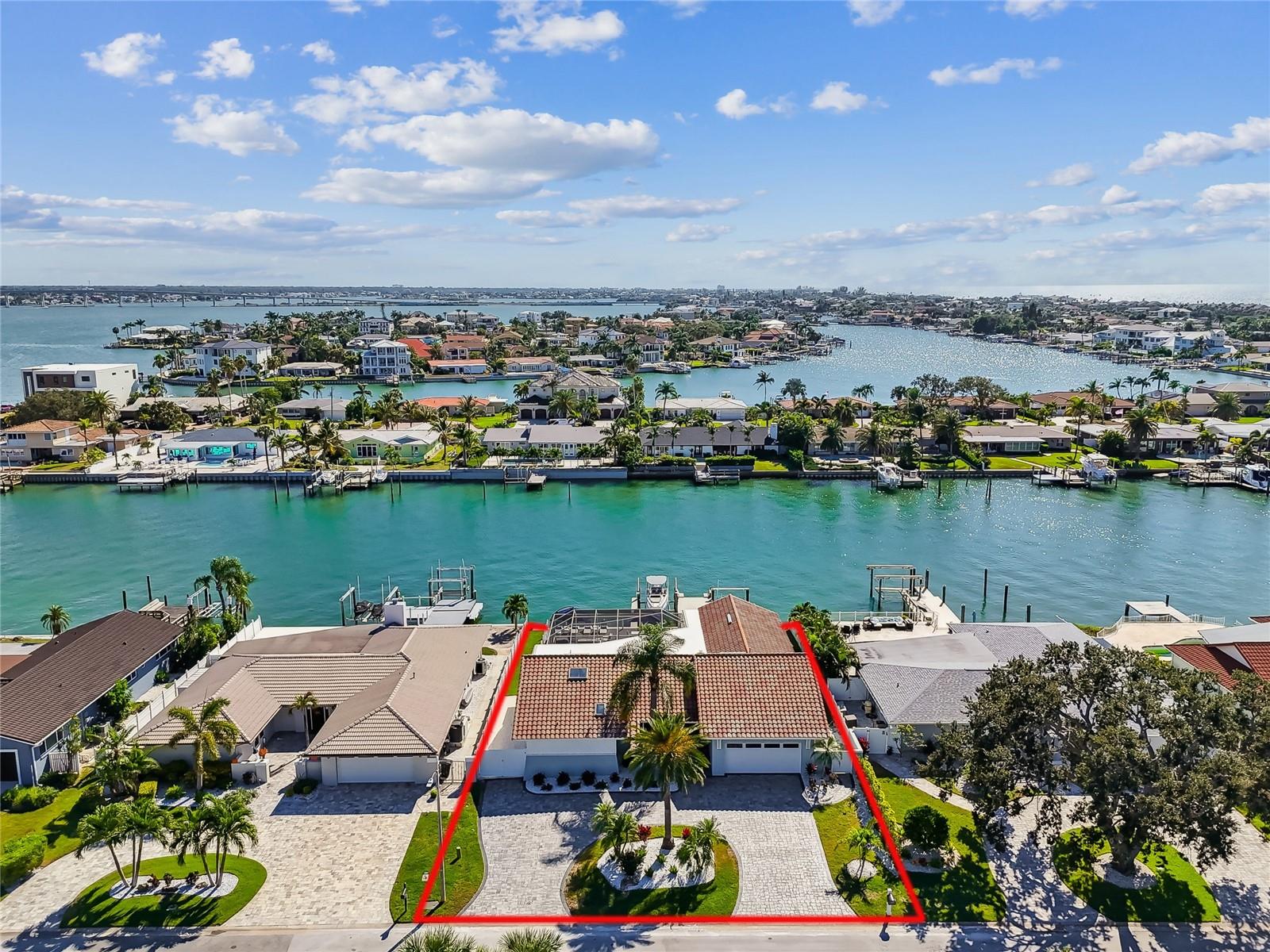 Completely Renovated Waterfront Luxury Home in Belleair Beach!  

Welcome to 320 Belle Isle Avenue,  a beautifully reimagined coastal residence offering the very best in Florida waterfront living. This elevated home (9.9 ft above sea level) had no interior flooding during any hurricanes, providing added peace of mind in a premium location.

This turn-key property has undergone a complete renovation inside and out, blending modern elegance with thoughtful functionality.  Features include all-new wide-plank flooring, fresh interior/exterior paint, upgraded lighting throughout, epoxy garage flooring, custom tile entry, a fully remodeled chef’s kitchen with an oversized peninsula and high-end Kitchen Aid appliances.

The luxurious primary suite boasts a spa-inspired bath with wet room, commercial grade steam shower and a custom walk-in closet. All bathrooms have been fully remodeled, including a stylish pool bath and a third full bathroom was added for enhanced convenience.

Outdoor living shines with a resurfaced pool, new pavered pool deck, new pool pump and heater, upgraded outdoor kitchen and shower, new pavered driveway, refreshed tropical landscaping, and a resurfaced waterfront deck with storage underneath.  All-new impact-rated windows and doors and a new garage door adds efficiency and storm protection.  The seawall and dock have both been redone, featuring a 16,000 lb boat lift and 8,000 lb dual jet ski lift with kayak/sup launch.

This is a rare opportunity to own in the highly sought after Belleair Beach community. Direct water access with close proximity to the Gulf, popular beaches, shopping and dining are the epitome of Florida living.  This home offers elevated peace of mind, luxurious finishes and the relaxed elegance that coastal living dreams are made of.