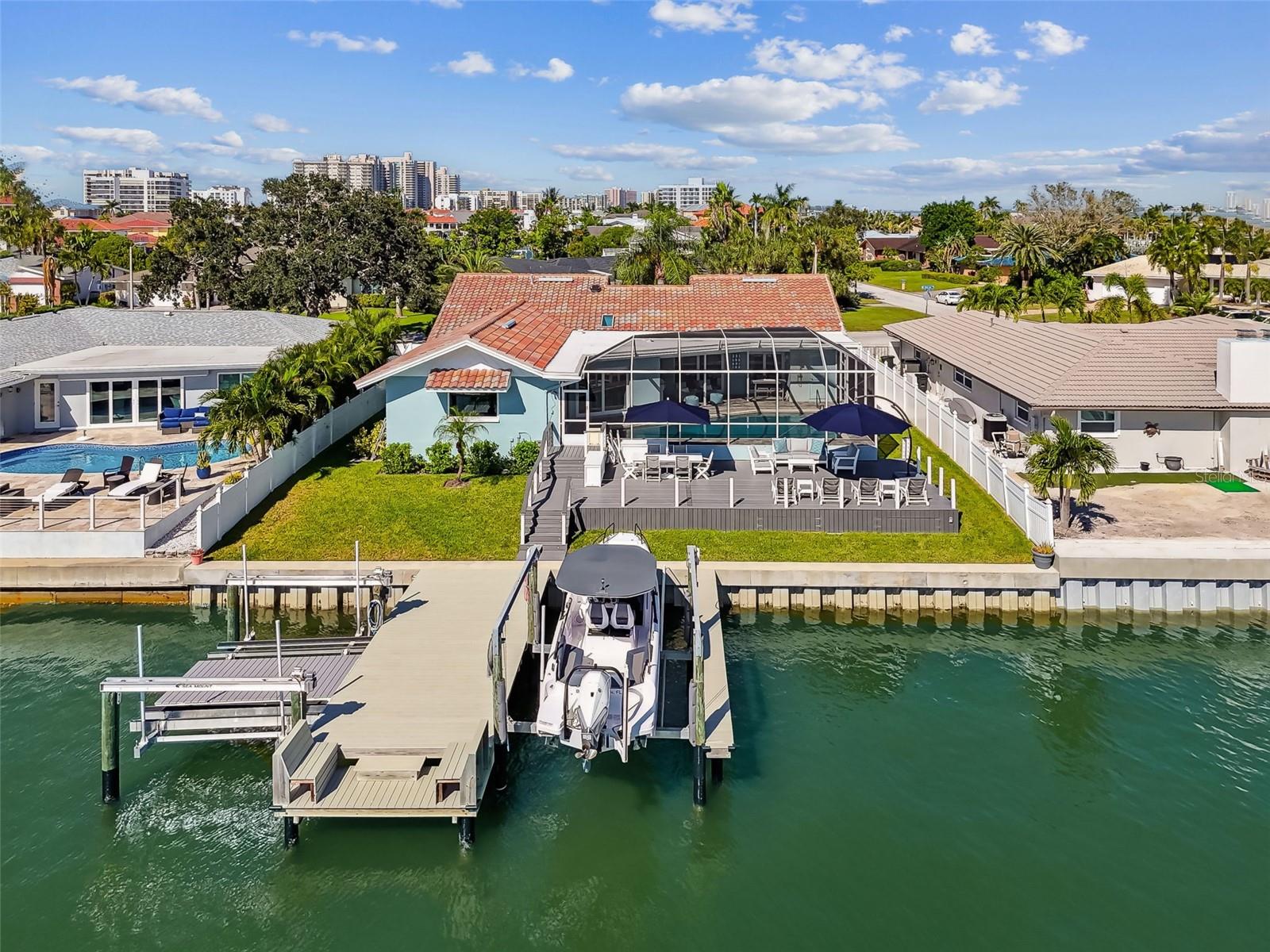New Price!  Exceptional Value in Belleair Beach!!

Welcome to 320 Belle Isle Avenue, a rare opportunity in the heart of one of Floridas most sought after beachfront communities, a place where location, luxury and comfort combine.  Perfectly positioned with direct water access and close proximity to the Gulf, this beautifully updated residence guarantees the very best that Florida waterfront living has to offer.

This elevated home (9.9 ft above sea level) had no interior flooding during any hurricanes, providing added peace of mind in a premium location.  As an added benefit, qualified buyers may have the opportunity to assume the seller's VA loan, subject to lender approval and VA loan assumption requirements.  Contact listing agent for details regarding current loan terms.

Thoughtfully enhanced between 2022 and 2025, nearly every aspect of the home has been elevated with designer selected finishes and premium improvements.  

Inside, an open concept floor plan filled with natural light showcases the high end finishes and creates a seamless indoor outdoor living space. The luxurious primary suite boasts a spa-inspired bath with wet room, commercial grade steam shower and a custom walk-in closet. All bathrooms have been fully remodeled, including a stylish pool bath and a third full bathroom was added for enhanced convenience.  The kitchen features new Kitchen Aid appliances and an oversized peninsula island, perfect for entertaining.  HVAC ductwork, furnace and AC were all replaced.  New flooring, paint and lighting throughout complete the fully updated interior.  All interior upgrades completed in 2022.

Outside, the waterfront backyard is equally impressive, perfect for relaxing, hosting or spending a day in the sun.  Outdoor living areas shine with a resurfaced pool, new paver pool deck, upgraded outdoor kitchen and shower, new paver driveway and exterior paint (all 2022).  The seawall and dock have both been redone (2022), featuring a 16,000 lb boat lift and 8,000 lb dual jet ski lift with kayak/sup launch.  All-new impact-rated windows and doors were added (2023) for extra efficiency and storm protection.  A resurfaced waterfront deck with storage underneath and new pool pump and heater were also added (2024).  Refreshed tropical landscaping and a new garage door (2025) further enhance the homes welcoming first impression.  The tankless water heater was also replaced (2026).

Every improvement was thoughtfully selected to enhance the home's coastal aesthetic, functionality, and long term value.  This turn key waterfront retreat is as beautiful as it is practical, and it is truly one of a kind.