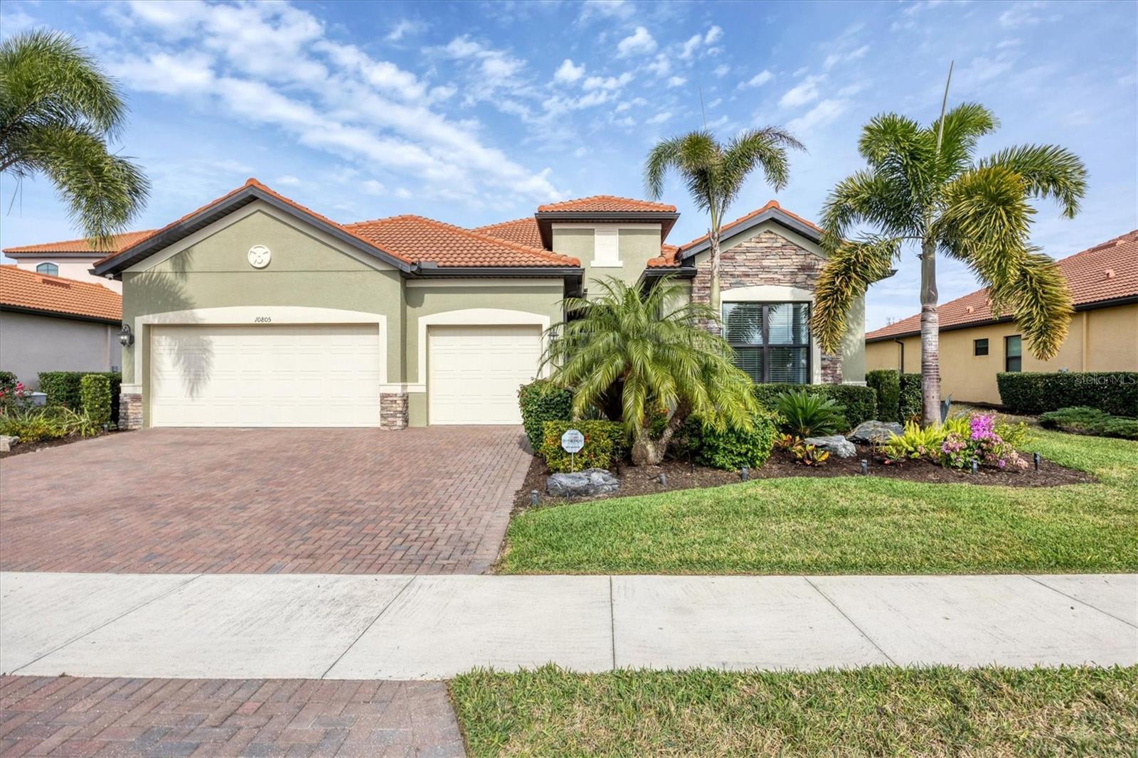 Welcome to this STUNNING home in the highly sought after SARASOTA NATIONAL GOLF AND COUNTRY CLUB! Come live in this VIBRANT community by letting yourself indulge in the most popular floor plan on the most coveted street in the neighborhood. Sitting at the end of this cul de sac street, this Summerville is sure to please w/tons of upgrades. Offering 3BD/3BA/DEN & 3 CAR GARAGE. TWO GOLF MEMBERSHIPS COME WITH THIS HOME, NO INITIATION FEE REQUIRED. When you drive up to the home curb appeal is off the charts w/ pavered drive/sidewalk, upgraded brick front, & leaded glass double doors all surrounded by beautifully designed tropical landscaping. Upon entering the home you will notice the rectangle plank PORCELAIN TILE flooring that runs throughout the main areas of the home. Walk through the foyer & come to the heart of the home-the GREAT ROOM, which brings living area, kitchen,& dining together in a functionally elegant combination. Gourmet Kitchen has GRANITE countertops, STAINLESS STEEL APPLIANCES (upgraded oven/microwave convection oven),extra large stainless steel FARMERS SINK, & easy pot fill HANSGROHE faucet. PENDANT LIGHTS, EXTRA RECESSED LIGHTS, & UNDER CABINET LIGHTING, makes sure the Chef doesn't miss a beat. KINETICO H2O double water filtration system & Revers Osmosis for drinking water. Crown molding, high end lighting & fixtures throughout home. Expansive Living room has gracious coffered ceiling design,& sliding doors out to the VERY PRIVATE,VERY SPACIOUS lanai & HEATED PRIVATE POOL/SPA. Lots of different areas to enjoy-float in the pool, soak in the hot tub, lounge in the sun, sit undercover rain or shine & enjoy the tropical landscaping all around the lanai creating your own private oasis. STORM SMART, REMOTE CONTROL HURRICANE SCREEN for lanai. Furniture can all be left undercover and protected. Master bedroom w/tray ceiling, sliders to lanai & has en suite bathroom that is a dream. Two separate vanities for individual space & a wondrous double shower that will elevate your senses. LARGE WALK IN CUSTOM DESIGNED CLOSETS. Guest bedroom 1 has en suite bathroom while guest bedroom 2 has its own private space and bathroom right next door. Laundry room offers wash sink & extra cabinets. 3 CAR GARAGE has lots of room for cars and storage. Two heavy duty storage racks to keep things off the floor. EV PLUG in garage(charger ready). HAVE YOU SEEN THE PROPERTY AT NIGHT?  Additional landscape lighting in front, back, & on lanai. Improved irrigation system with Hunter remote control for programmed scheduling. Added additional sprinkler heads in front and back.  No expense was spared on this GORGEOUS home so MAKE YOUR APPOINTMENT TO SEE IT TODAY!! Sarasota National is a magnificent community w/over 1300 acres designated for preservation, conservation, lakes, & open space with amazing views, Proclaimed as an Audubon International Certified Sanctuary, making it the most gorgeous and enjoyable golf course to play at in the area. Offering resort style amenities w/huge resort style pool/ spa,Tiki Bar to serve refreshing drinks & a bite of lunch, tennis courts, pickle ball, Bocce courts, coffee lounge/library/card room/meeting place, 7000 sq ft fitness facilities offering classes and day spa, & a 30,000 sq ft Clubhouse with dining and spectacular views. 18 Hole championship golf course surrounded by native wetlands and preserves provides an exhilarating and dramatic back drop for your golfing adventure. Come find YOUR Florida lifestyle TODAY!