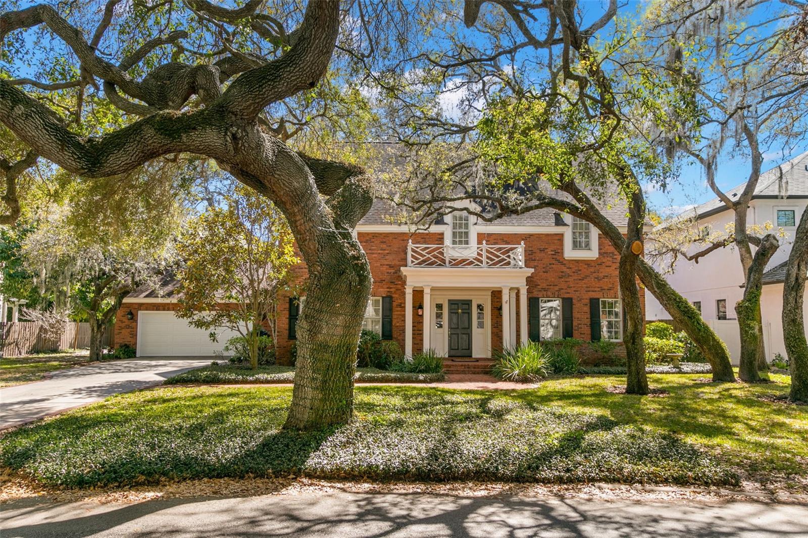 One or more photo(s) has been virtually staged. Quietly nestled on arguably the most beautiful street in South Tampa, this 3 story, 5 bed, 4.5 bath traditional style home offers over 4200 square feet of space and rests on an oversized lot just a half block from Bayshore Blvd. The 109' x 120' ft lot is nearly double the standard size and is adorned by multiple fruit trees (mango, orange, key lime, fig), gorgeous Magnolias, mature Oaks, an expansive brick patio, a side yard basketball court, and plenty of parking space in addition to the 2 car garage. The interior of the home features timeless touches such as crown molding, a raised brick hearth in the Family Room, and formal living and dining rooms, yet the layout still allows ample flexibility for new buyers. The first floor is highlighted by a modern kitchen that includes stainless steel appliances, shaker style cabinets, island, pantry, bar, gas stove with retractable exhaust fan, and stunning marble countertops. The kitchen opens up to the Family Room which stays flooded with natural light during the day thanks to multiple windows and sliding glass door that lead to the back patio.  Spend time with family and loved ones around the warmth of a fire in the wood burning fireplaces over the holidays or spend time outdoors in the back yard which offers plenty of room for a new pool. The second floor includes 4 bedrooms and 3 full baths, all with brand new quartz countertops and faucet hardware. Designed with utmost consideration, the master bathroom offers a double vanity and "his & hers" walk-in closets.  The 3rd floor could be utilized as an in-law suite, playroom, lounge, recreation room, or anything else you could imagine, as it has a spacious living area, a large bedroom with a walk-in closet, and en suite full bathroom. The property also has 2 private wells, one supports the irrigation system, and the second supplies and recycles water through the geothermal heat pump. This structurally sound, brick home sits in an X flood zone, meaning no required flood insurance and peace of mind during hurricane season. Take strolls down Bayshore Blvd to watch the magnificent sunrise, or take a quick drive down to Hyde Park Village, SoHo, or downtown Tampa to enjoy fine dining and premier shopping. This home is all you could ask for. Please note listing agent is related to sellers.