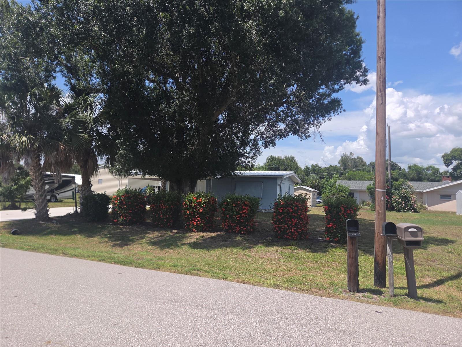 What a find!  NO HOA!  TWO PARCELS, made up of 2 lots each.  Cement Block house with screened lanai and storage sheds.  Beautiful mature oak to provide the ultimate shade!  Close to all of Punta Gorda's fun social life, with great restaurants close by!  Laundry is inside in the utility room.  2 bedrooms and 1 bath, but an open floor plan in the main part of the house. Ceramic tile floors in the wet areas, with carpet in living room and bedrooms. Plumbing updated.  Metal Roof.  2019 AC.  Well/Septic means NO WATER BILLS.  Spectrum Internet/Cable available.  Perfect for a starter home, a snowbird escape, or an investor's income producer!