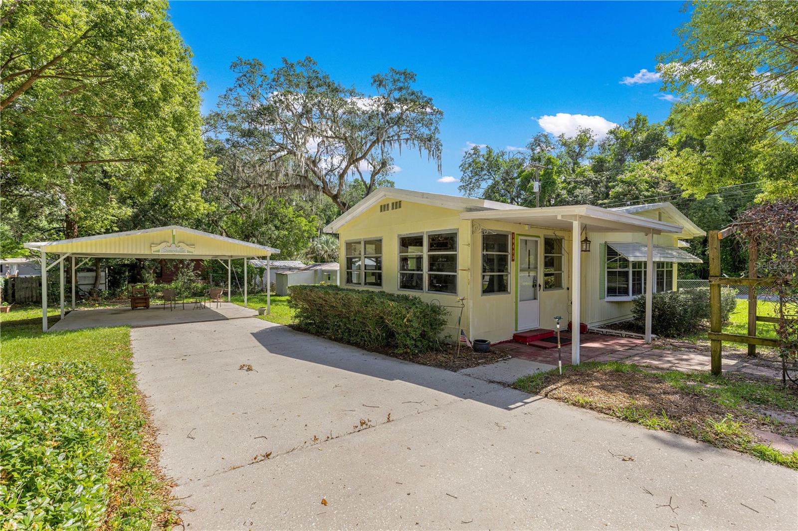 ***Charming & Updated Home in Lake Weir Village**
Enjoy the best of Florida living in this beautifully updated 2-bedroom, 2-bathroom home, perfectly situated on a generous .28-acre fully gated lot. Whether you’re looking for a move-in-ready primary residence or a getaway near the water, this property delivers.
Key Features & Recent Upgrades:
Peace of Mind: Features a 2021 A/C unit, 2022 new meter panel and pole, New Well Pump and  all tie-downs were brought up to code in 2018.

Modern Interior: Enjoy updated flooring throughout and a clean, move-in-ready interior.

Outdoor Living: Includes a spacious 2-car carport, a dedicated storage shed, and a versatile enclosed patio/mudroom.

The Lot: The large, fully gated yard offers privacy and plenty of room for pets or hobbies.

Unbeatable Location:
Water Access: Comes with deeded access to Little Lake Weir.

Proximity: Located just one mile from Carney Island and Lake Weir, offering easy access to boating, fishing, and recreation.

Convenience: Includes a dedicated laundry room and plenty of storage space.

This home is in pristine condition and ready for its next owner