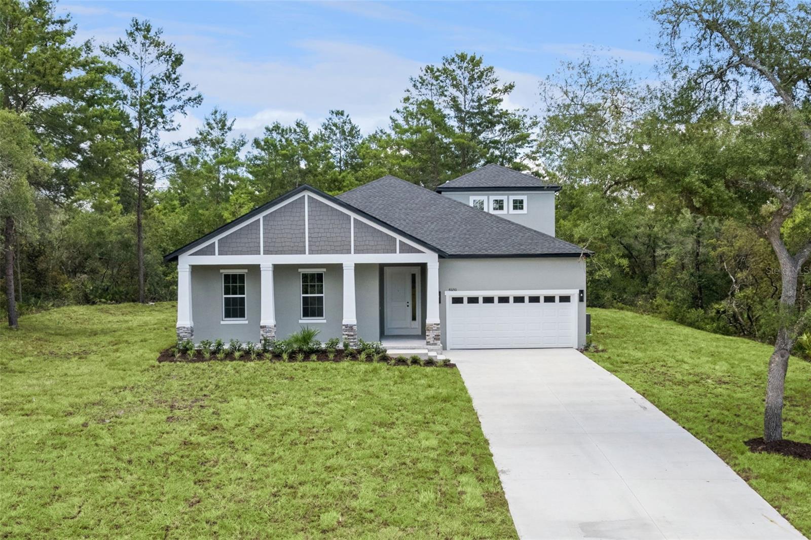 New Construction (2026) – Move-In Ready! This 2,715 sq. ft. concrete block home offers 4 bedrooms, 3.5 bathrooms, including a Large second floor Bonus Room with Full Bathroom, and a 2-car garage on a spacious 1-acre lot in the sought-after Royal Trails Equestrian Community of Eustis, Florida. Featuring 10-foot ceilings and modern upgraded finishes throughout, this home includes quartz countertops, all-wood shaker-style soft-close cabinetry, luxury vinyl plank flooring, and upgraded tile in the bathrooms. Around 15 minutes to the St. Johns River and 25 minutes to all of the festivities in Downtown Mt. Dora! The open-concept layout provides a well-appointed kitchen and living area ideal for both everyday living and entertaining. A dedicated laundry room adds convenience. The primary suite offers a spa-like retreat with dual vanities, a large walk-in closet, glass-enclosed walk-in shower, separate soaking tub, and private water closet. Enjoy peace and quiet and reconnect to the natural Florida landscape with ample space to add a pool or detached workshop. Zoning allows up to 2 horses pe acre. Royal Trails residents enjoy access to equestrian trails, a community park, and a private boat dock to Lake Norris—a pristine 1,200-acre freshwater lake in Lake County. Outdoor lovers will appreciate direct access to the renowned Florida National Scenic Trail, which spans nearly 1,500 miles across some of Florida’s most beautiful landscapes and passes right through the community. The Royal Trails Community Center offers an air-conditioned venue perfect for hosting events, gatherings, and celebrations. Low HOA fee of $92/year. Experience the perfect blend of privacy, nature, and modern living—schedule your showing today! **All information, measurements, HOA, tax information, etc. are deemed accurate, but buyers should verify. List agent has interest in property**