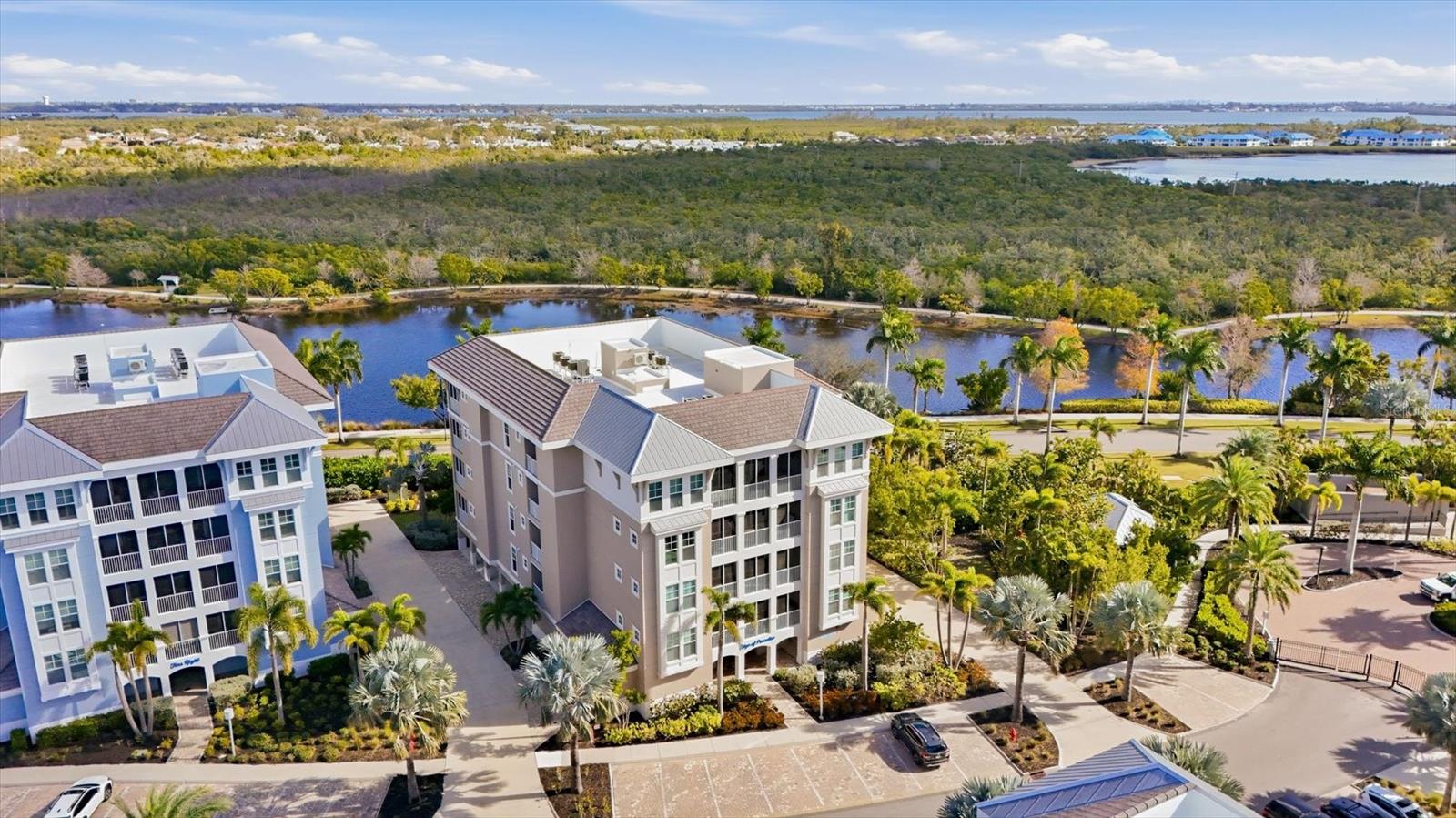 Virtually Staged. PRICE IMRPOVEMENT and new, reduced condo fees! Welcome home to Harbour Isle, where refined coastal living meets effortless luxury. This rare end-unit condominium offers complete privacy, with no
adjacent buildings and unobstructed, tranquil lake and Preserve views. Never rented and meticulously maintained by the original owner, this home is
being sold partially furnished and feels like new while boasting over $40,000 in premium builder upgrades. The custom Oceana floorplan features dual
primary suites with a split design, providing privacy for hosts and guests alike. The open layout offers ample space for entertaining or utilizing as a
short- or long-term rental. The spacious kitchen features stainless steel appliances, solid wood cabinets, stone countertops, and thoughtful designer
touches. Owner enhancements include upgraded LED lighting throughout and Smart features, including network cameras with no subscription
required. Hurricane-rated triple sliding glass doors seamlessly open the living area to the lanai, creating the perfect space for entertaining family and
friends in comfort, complete with new no-see-um tight specialized screening. Convenience and security are built in, with covered under-building
parking, a private storage unit, and 24-hour virtual guarded gate.  Designed for those who value exclusivity and ease, the private, resort-style
community is anchored by the spectacular 23,000-square-foot Beach Club overlooking Anna Maria Sound. The waterfront Sky Bar, on-site dining, resort style pool and spa, private beach, and kayak launch create your own coastal retreat, steps from home. Residents enjoy four beautifully designed pools,
state-of-the-art fitness center and sauna, fire pits, grilling areas, hammock park, lakeside swings, and miles of scenic walking and biking trails.
Surrounded by nature, Harbour Isle sits steps from Neal Preserve and minutes from Robinson Preserve for kayaking, trails, and birdwatching. Just
beyond the gates, enjoy the Margaritaville-inspired Compass Hotel, Floridays Tiki Restaurant, Compass Bar & Chill, and marina access at Pier 77, offering
wet and dry storage, Gulf access, and Freedom Boat Club. Located 1-2 miles from the pristine beaches, local shops, and dining of Anna Maria Island,
Harbour Isle offers a rare blend of privacy, convenience, and resort-level amenities. This is more than a home, it is a lifestyle investment in exclusive
coastal living, ideal for full-time residents, seasonal owners, or investors seeking income-producing potential. Schedule your private tour today.