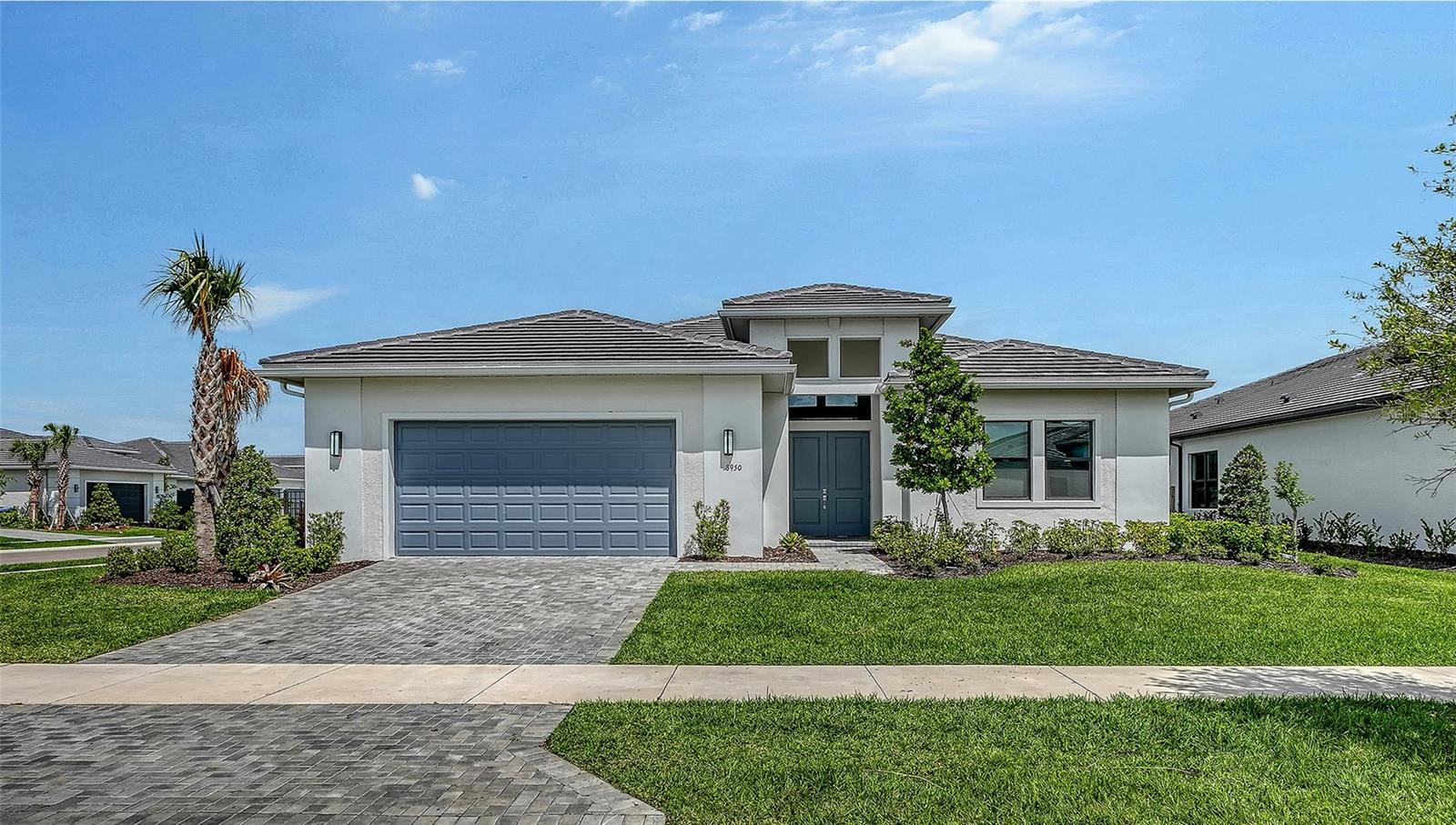 NOW PRICED TO SELL! 50k PRICE REDUCTION! Welcome to this exceptional 2024-built Van Gogh model by Kolter Homes, a rare single-story residence set within the highly sought-after gated community of Artistry Sarasota. Offering 3,066 square feet of thoughtfully designed living space, this 3 bedroom plus office/den, 3 bath home embodies a seamless blend of architectural sophistication, modern comfort, and maintenance-free living. A gracious tile-floored foyer sets the tone, welcoming you into an interior defined by clean lines, volume ceilings, and refined finishes throughout. The open-concept layout unfolds into a formal gathering room adorned with custom tray ceilings, flowing effortlessly into a beautifully composed living and dining environment designed for both everyday living and elevated entertaining. Expansive hurricane-impact windows and doors bathe the home in natural light, enhancing the sense of openness while providing peace of mind. At the heart of the home is the gourmet kitchen—anchored by a striking waterfall-edge center island and complemented by abundant counter space, sleek cabinetry, and a substantial walk-in pantry. Outfitted with premium stainless-steel appliances, including a natural gas 30-inch cooktop with vented hood, built-in microwave, thermal wall oven, and dishwasher, this space is designed to inspire both casual meals and culinary pursuits. A breakfast nook offers a relaxed setting for morning coffee, while the adjacent dining area provides an inviting backdrop for more formal gatherings. The private office or den offers a quiet, dedicated workspace ideal for remote work or creative pursuits. The primary suite serves as a serene retreat, featuring coffering ceiling, a sunlit bay window, and a spacious walk-in closet. The spa-inspired bath is thoughtfully appointed with dual vanities and a frameless glass-enclosed oversized shower, creating a calming, refined atmosphere. Two additional guest bedrooms are generously sized and well-positioned, offering comfort and privacy for family or visitors. A well-designed laundry room enhances daily functionality with upgraded cabinetry and a utility sink. Throughout the home, custom motorized window treatments add both convenience and a polished aesthetic, while energy-efficient systems—including open-cell spray foam insulation, high-efficiency HVAC, and a tankless water heater—underscore the home’s modern performance and sustainability. Outdoor living is equally compelling. A custom screened lanai, pre-plumbed for a future summer kitchen, invites effortless indoor-outdoor entertaining. The beautifully newly landscaped, fenced corner lot provides both privacy and space to unwind in a tranquil setting with plenty of room for a pool! Residents of Artistry enjoy access to an array of resort-style amenities, including a state-of-the-art fitness center, lap and resort-style pools, outdoor cabanas, a spa, basketball court, playground, and scenic walking trails set among lush landscaping and serene lakes. Ideally located just minutes from premier shopping, dining, top-rated schools, and Sarasota’s renowned beaches, this residence offers an unparalleled lifestyle opportunity. Move-in ready and meticulously upgraded, this is a rare offering that combines timeless design, modern innovation, and an exceptional Sarasota location.