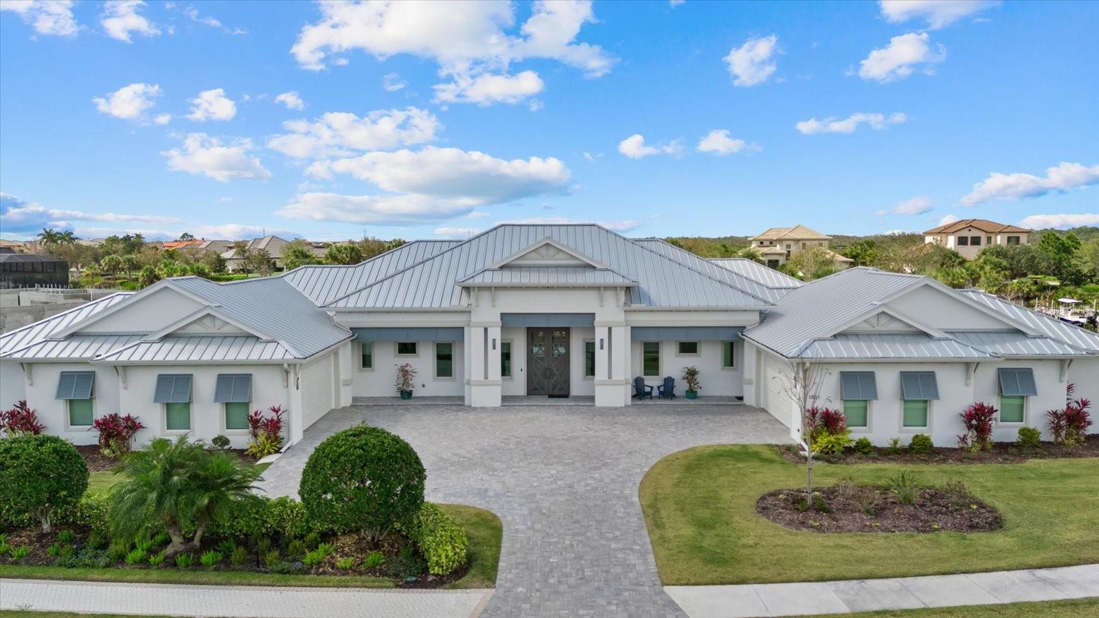 This extraordinary custom waterfront residence with a saltwater pool & spa in the Islands on the Manatee River blends luxury design, cutting-edge technology & direct boating access to the Gulf with no locks. Set on a private, nearly acre homesite, the impressive 131-foot-wide estate, completed in December 2024, offers 4,200 square feet of luxurious living space - with 7,200 total square feet under roof, including an expansive 8-car garage & large covered lanai space perfect for entertaining & enjoying the stunning water views. The home features 185 feet of waterfront living & a private dock with a 20,000-pound lift, making it a dream property for boating enthusiasts. 

Inside, the thoughtfully designed open-concept floor plan includes 4 bedrooms with en-suite baths, den/office, bonus room, half bathroom & storage room, all finished with exceptional craftsmanship including 11-foot ceilings, upgraded LVP flooring throughout, 8-foot solid wood doors with extra wide openings, crown molding, vaulted ceilings, wood accented ceilings, impact-resistant Anderson windows & PGT doors.

The chef’s kitchen is the centerpiece of the home, showcasing Thermador appliances, a built-in double oven, gas range with griddle & downdraft vent, 60-inch Dacor column refrigerator/freezer, 42-inch shaker-style wood cabinetry with upper cabinets, large quartz island, farmhouse sink, hidden walk-in pantry, coffee station, a wet bar with wine refrigerator & additional sink. The adjoining living room features 14-foot vaulted ceilings, custom built-ins & a dramatic 24-by-10-foot pocket sliding glass door that opens seamlessly to the outdoor living area.

Designed for true Florida living, the expansive lanai offers nearly 1,000 square feet of covered entertaining space, highlighted by a pool/spa with gas heater, panoramic screen enclosure, upgraded pavers, a fully equipped outdoor kitchen with Blaze grill & cooktop. Additional outdoor spaces include a fire pit, patio & beautifully landscaped yard. A spacious bonus room with zero-corner sliding impact glass doors, surround sound & water views provides the perfect space for entertaining.

The luxurious primary suite features French doors to the lanai, large dual walk-in closets & a spa-inspired bathroom with freestanding tub, quartz vanities, walk-in shower with rain head & dual showerheads. 

Built with high-end systems & modern efficiency, the home includes two Navien tankless gas water heaters, a 500-gallon propane tank, whole-house water filtration, reverse osmosis drinking water system, Cat6 wiring throughout, multi-zone surround sound, security system with 4K cameras, powered Roman shades, Wi-Fi irrigation from a private well & automated landscape lighting.

The oversized eight-car garage offers exceptional flexibility for car enthusiasts or storage, featuring epoxy floors, insulated hurricane-rated doors, spray foam attic insulation, Wi-Fi LiftMaster openers with cameras, EV charging & rear garage access to the backyard.

Residents enjoy access to a community space with gym, great room, fire pit, bocce court, putting green & day dock. Optional golf memberships available at River Wilderness Golf & Country Club. Located 3 miles from Lakewood Ranch, with easy access to airports, shopping, dining & beaches.

This property offers a rare opportunity to enjoy custom luxury, modern efficiency & direct Gulf boating access. A full feature sheet is available detailing the extensive enhancements throughout.