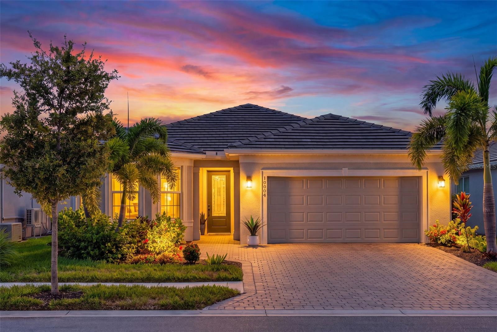 **Effortless Coastal Living — Beautifully Upgraded Water View Prosperity Model in BeachWalk by Manasota Key**

Welcome to 10004 Coral Shore Drive, where luxury, comfort, and the Florida lifestyle come together in the highly sought-after gated community of BeachWalk by Manasota Key. This beautifully upgraded Prosperity model offers the perfect blend of style, functionality, and low-maintenance living — ideal as a seasonal Florida retreat or a year-round residence.

Designed with today’s lifestyle in mind, this thoughtfully planned home features 2 bedrooms, 2 bathrooms, and a versatile flex room with upgraded glass doors — perfect for a home office, hobby space, fitness area, or additional guest accommodations. The open-concept design creates an inviting flow with large ceramic tile flooring throughout, elegant tray ceilings in the main living area, upgraded window shades, a charming bay window, and an abundance of natural light.

From the moment you arrive, you’ll appreciate the added upgrades including a beautiful high-impact glass front door and hurricane shutter protection at the front of the home for additional peace of mind.

The gourmet kitchen is the heart of the home, showcasing upgraded KitchenAid stainless steel appliances, premium cabinetry, under-cabinet lighting, and a beautifully customized pantry complete with a coffee bar — the perfect place to start your morning before heading out to enjoy the Florida sunshine.

The spacious gathering room opens seamlessly to the extended lanai, creating the indoor/outdoor lifestyle everyone is searching for. Relax with your morning coffee, entertain friends, or simply unwind while enjoying the tranquil water views and spacious backyard setting.

The owner’s suite offers a peaceful retreat, while guests will appreciate their own comfortable space with an upgraded guest bathroom featuring designer tile finishes and a tub/shower combination.

Additional upgrades include epoxy garage flooring, a 4-foot garage extension providing valuable extra space for storage, bikes, beach gear, or hobbies, along with numerous designer enhancements throughout.

Located in BeachWalk by Manasota Key, one of Southwest Florida’s premier gated resort-style communities, residents enjoy a vacation-inspired lifestyle every day. Just minutes from Manasota Key beaches, BeachWalk offers incredible amenities including a resort-style pool, lap pool, spa, state-of-the-art fitness center, movement studio, clubhouse, High Tide Bar & Grill, coffee and smoothie bar, 10 pickleball courts, 5 tennis courts, bocce courts, fire pits, dog park, scenic walking trails, community events, and a beautiful boardwalk surrounded by nature.

Golf-cart-friendly living, nearby beaches, boating, shopping, dining, and endless activities make BeachWalk the perfect place to enjoy everything Southwest Florida has to offer.

Whether you are searching for your winter escape or your forever Florida home — this Prosperity model is ready to welcome you home.